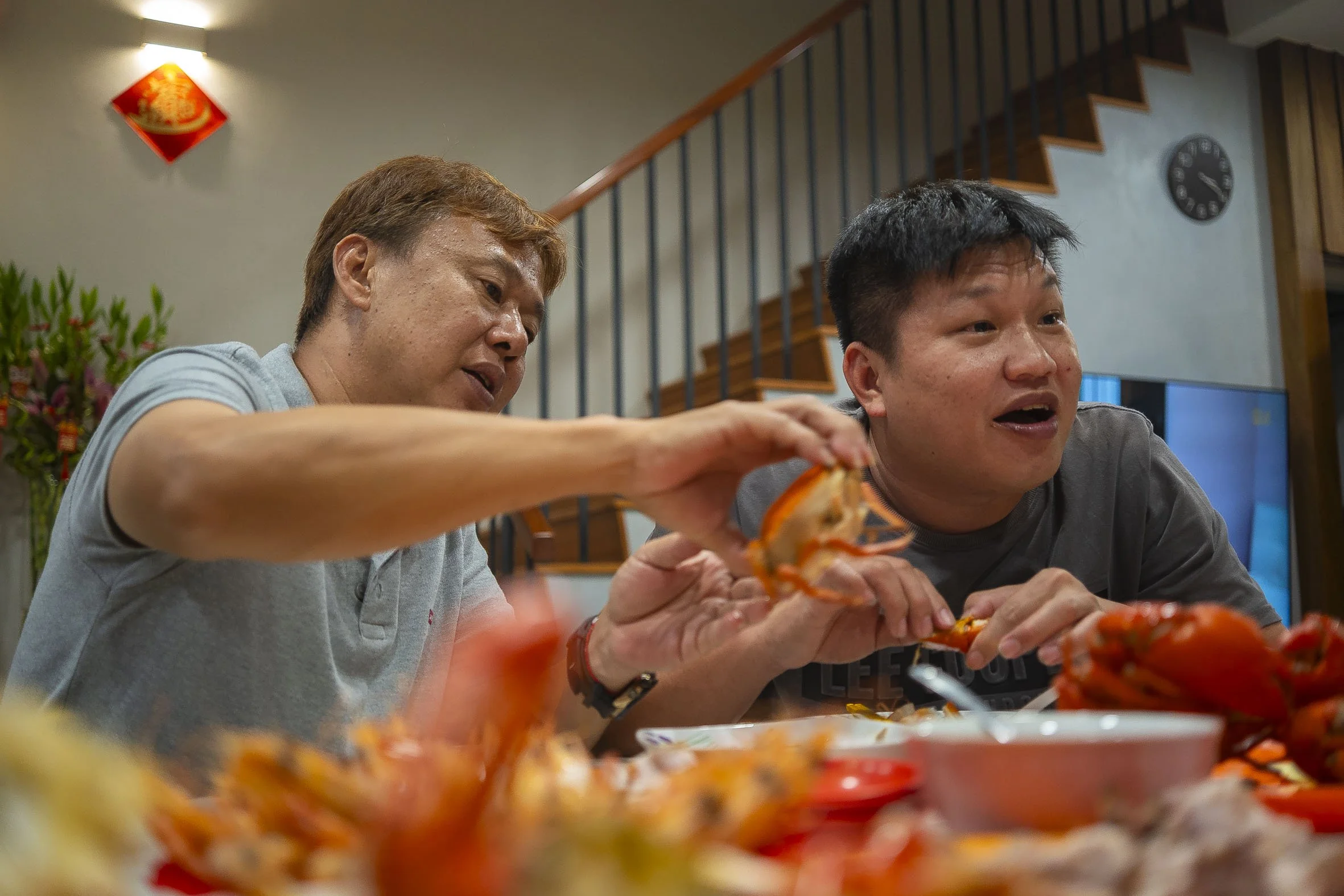 Meanwhile, a few who stayed in the house like Mdm Lim had begun preparations for supper.   As Mdm Lim brought out a piping hot bowl of porridge, guests helped themselves to the feast of offerings. Mr Ku Yee Cheng (right), 41, an events decoration man