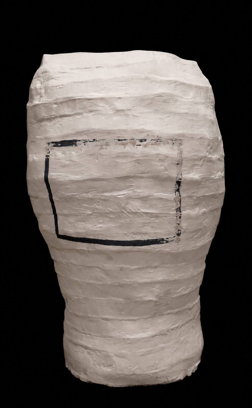 A white, textured, paper lamp with a black rectangular outline and some black markings on a black background.