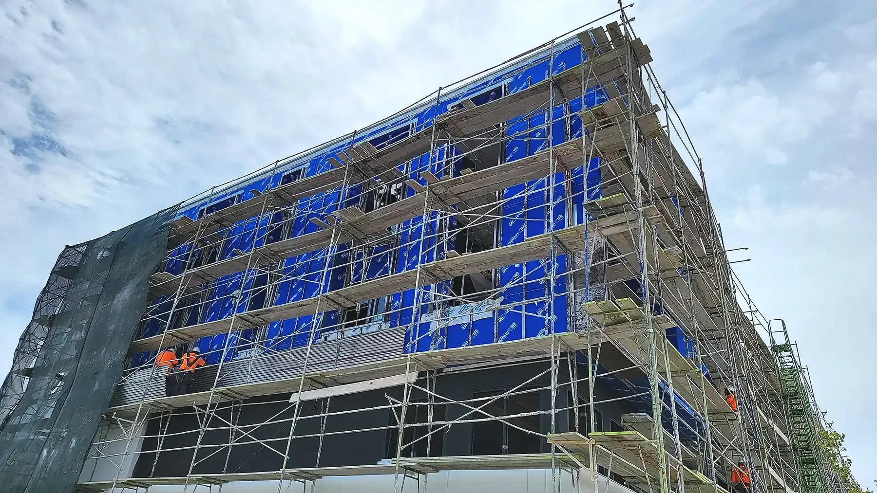 building in construction showing wrap