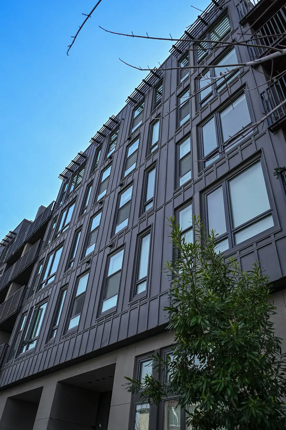 detail view of platform apartments looking up from sidewalk