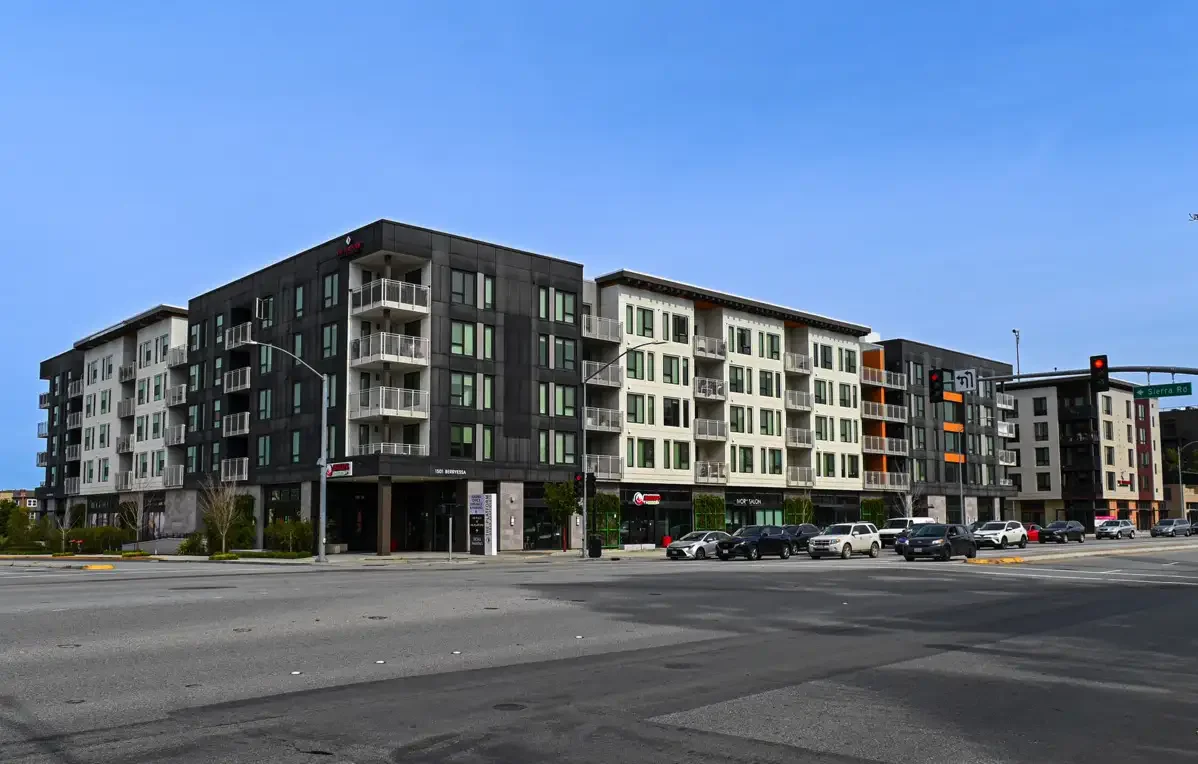 wide shot of platform apartments from across street