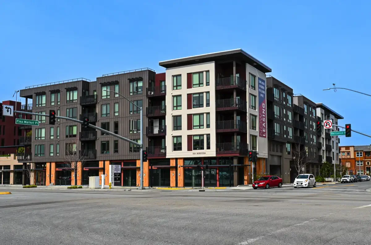 alternate wide shot of platform apartments from across street