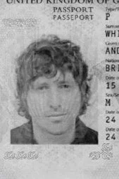 Black and white photo of Andrew Whitton with short, curly hair on a passport.