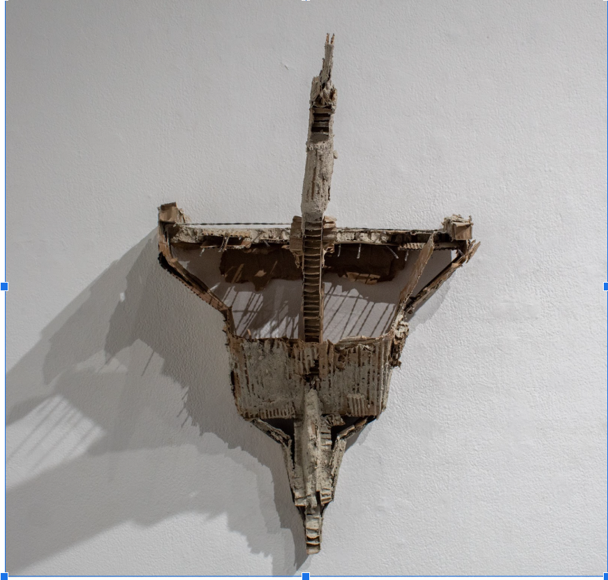 David Lujano 

Interstate Voyage, 2025 
Cardboard,In Interstate Voyage, the artist combines the forms of the ships of discovery and U.S interstate infrastructure. Highlighting their similarities in utilization, to displace or remove undesired populat