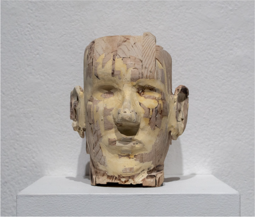 David Lujano  
Niñez, 2025 
Wood

In this piece, the artist explores their own childhood from the perspective as an adult. From the process of building the form with pieces of scrap wood, using putty to fill the gaps between the cracks, and sanding t
