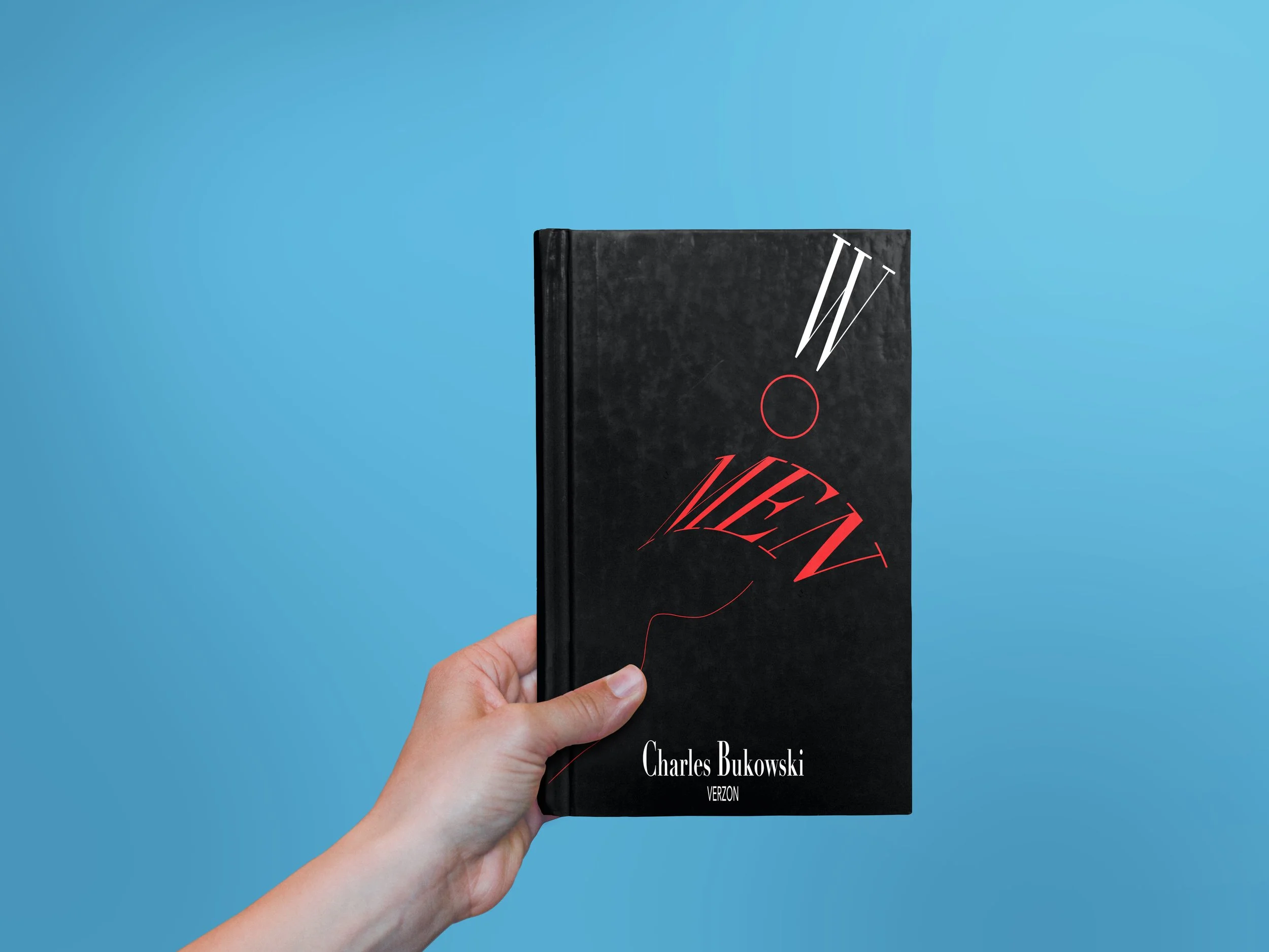 A person's hand holding a black hardcover book titled 'WOMEN' with red and white stylized text, against a light blue background.