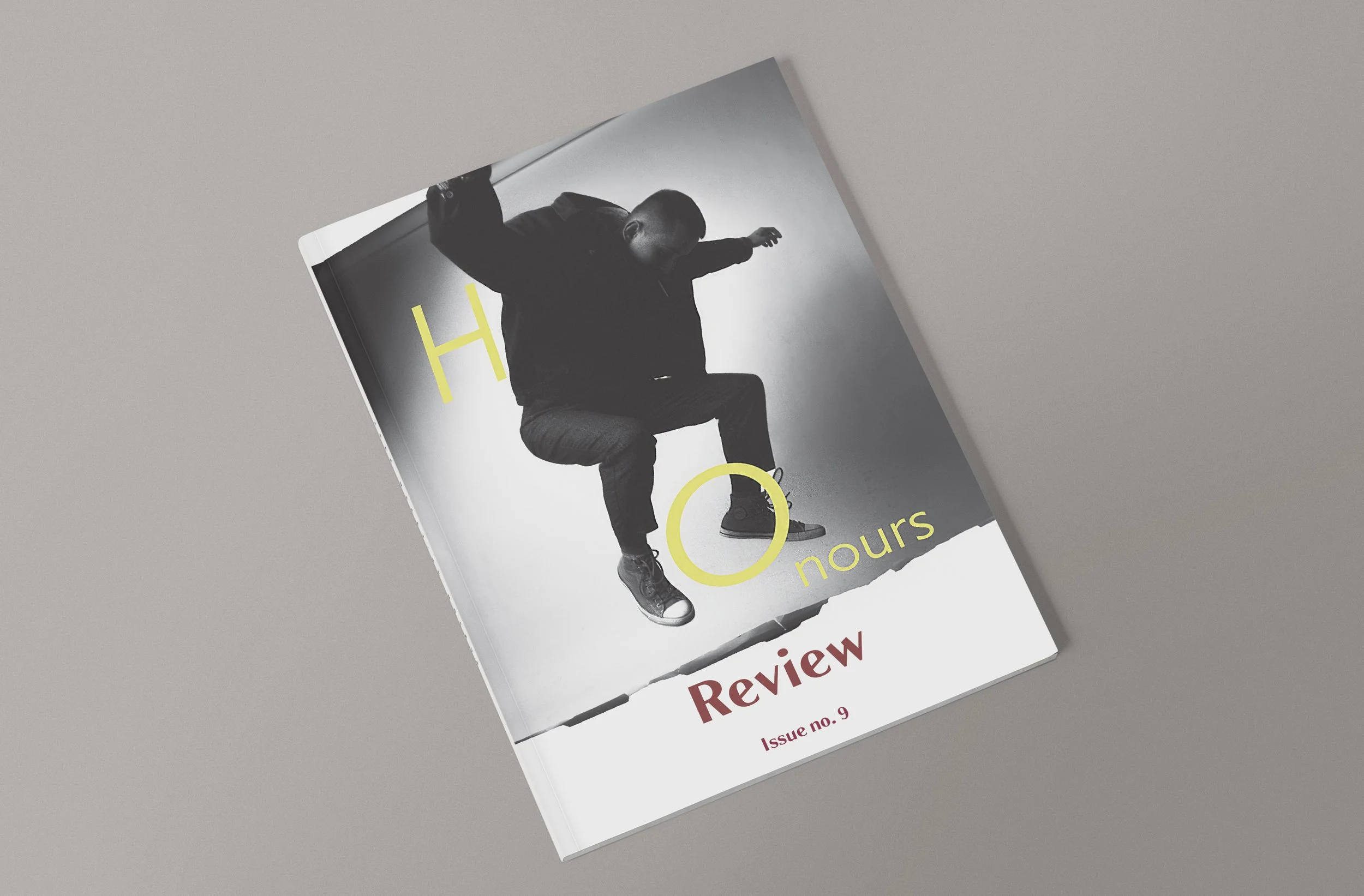 A black and white magazine cover with a person in mid-air, arms and legs extended, wearing a black jacket, gray pants, and black sneakers. The cover features the large yellow text 'H 0 heures' and smaller red text 'Review Issue no. 9'.