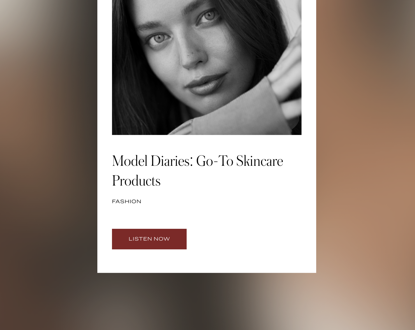 Black and white photo of a young woman with long hair, looking directly at the camera with a slight smile, resting her face and hand on her arm.