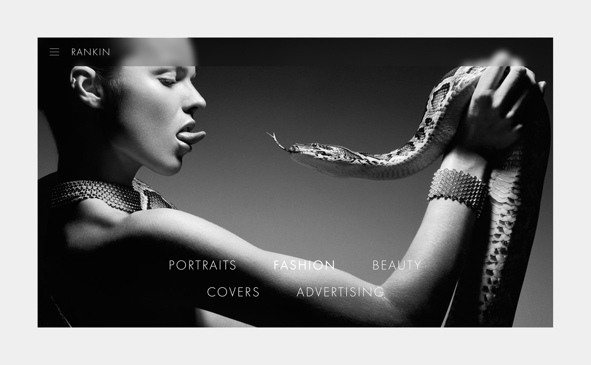 Black and white image of a woman holding a snake with her right arm. The woman has her tongue slightly out and is wearing a metallic, scaled bracelet. The background is plain, and the image is part of a website menu with options including portraits, 