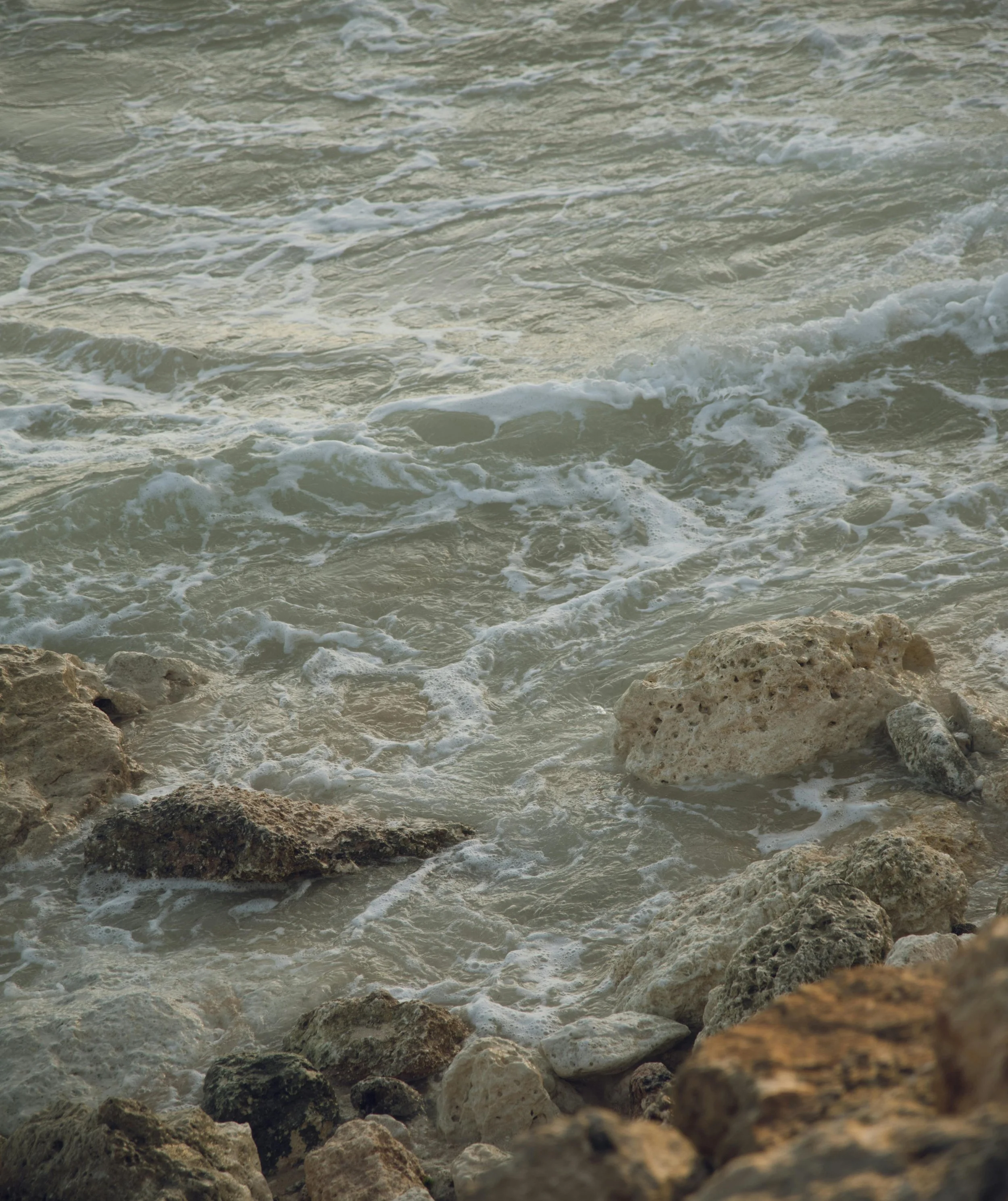 Waves crashing on rocky shoreline at the beach