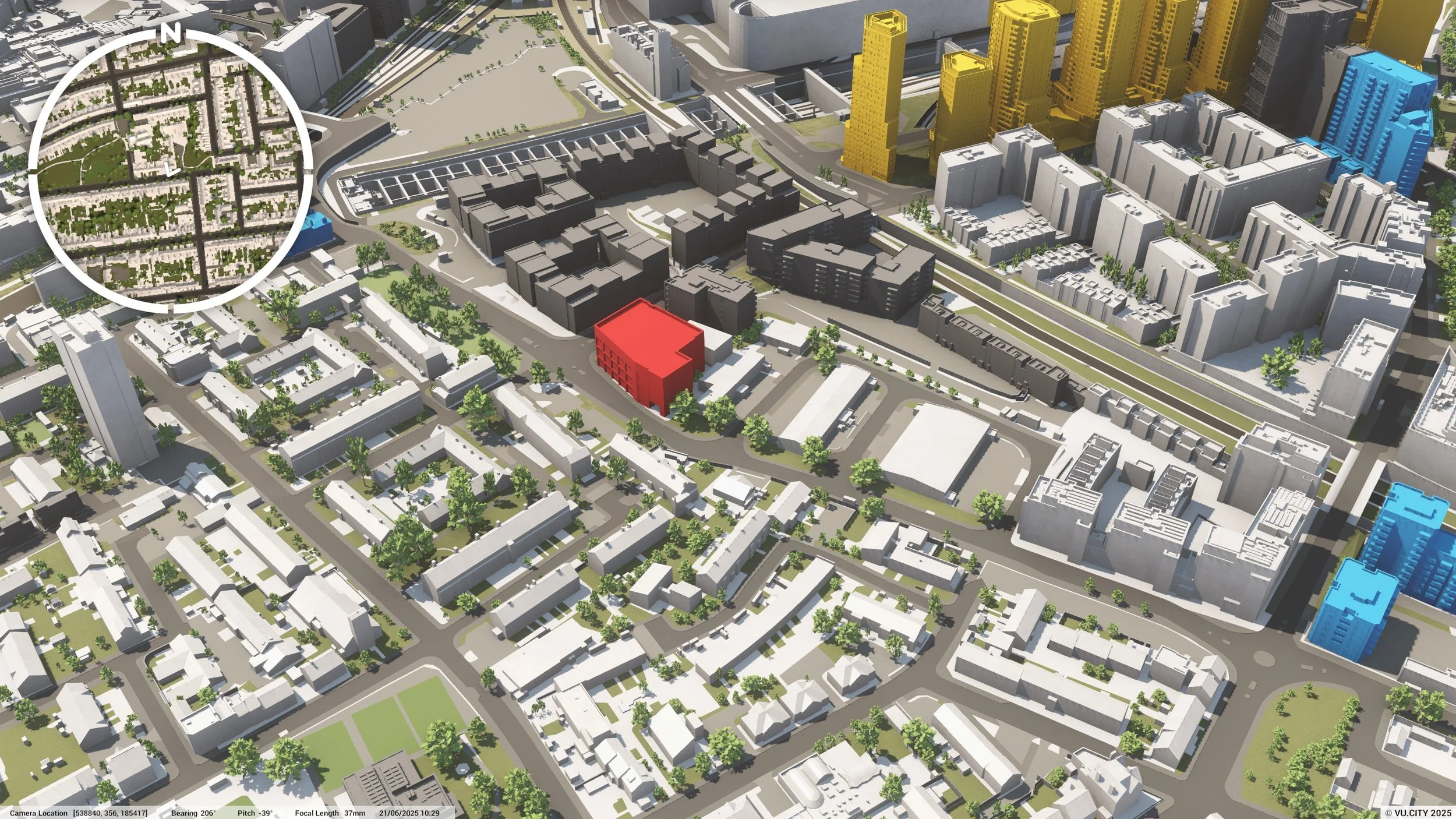 Aerial view of a city block with a red building in the center, surrounded by residential homes, commercial buildings, and streets lined with trees. City skyscrapers are visible in the background.