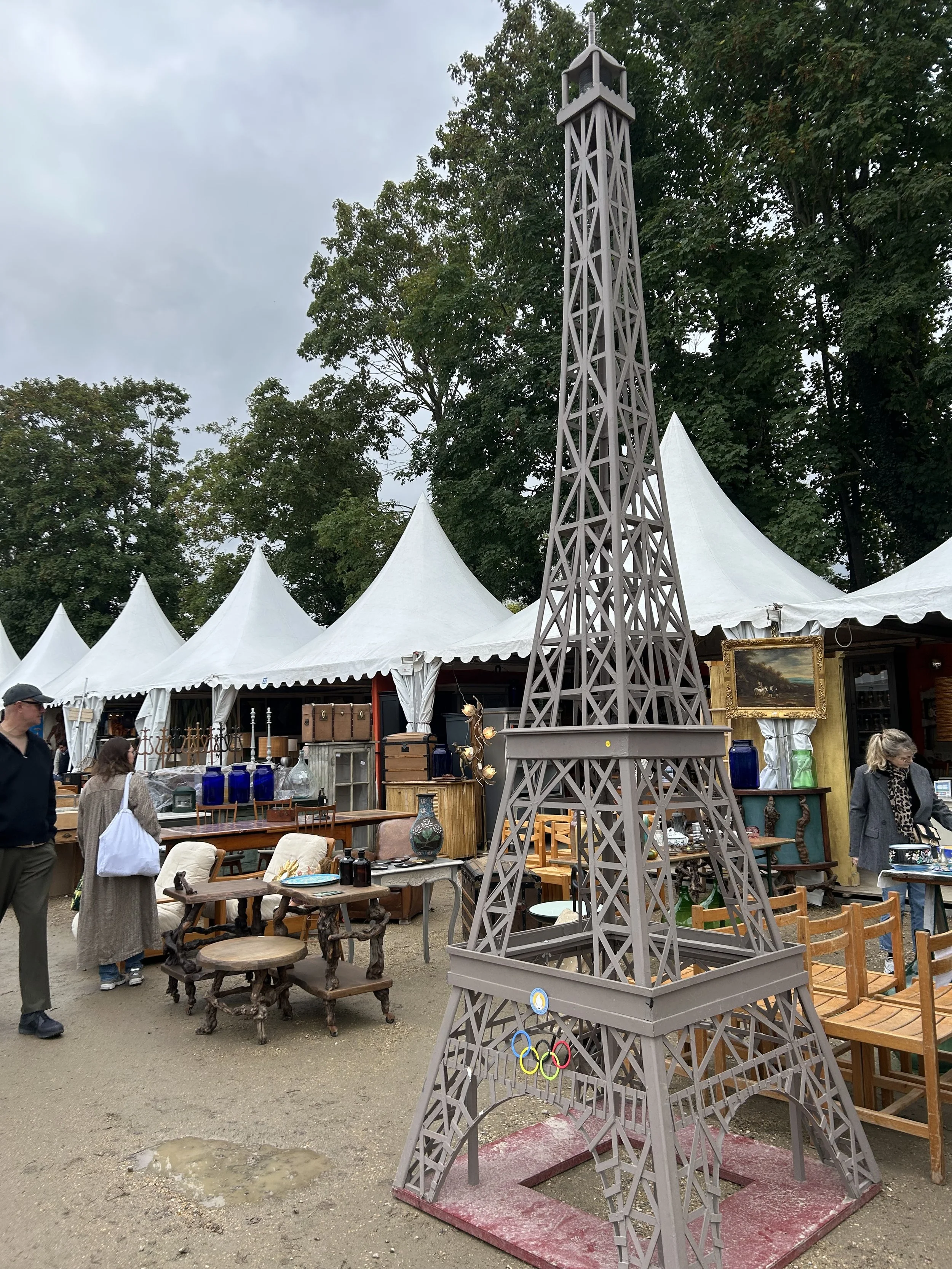 Miniature Eiffel Tower replica at an outdoor market Foire de Chatou in Paris.