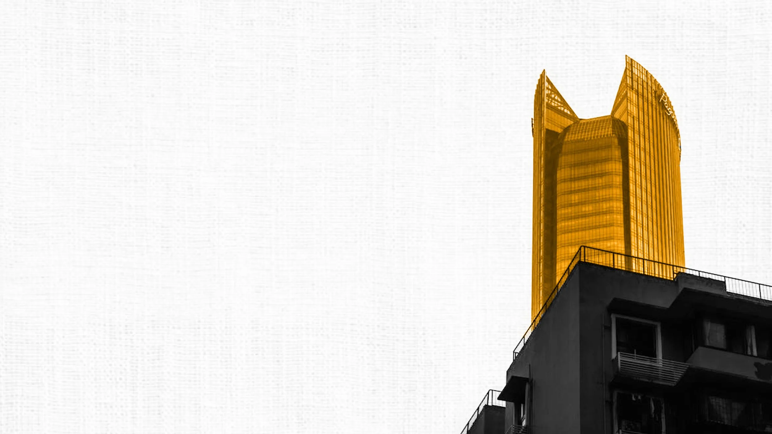 Hospital room with two unoccupied beds, medical equipment, and a small desk with chairs against a white wall.