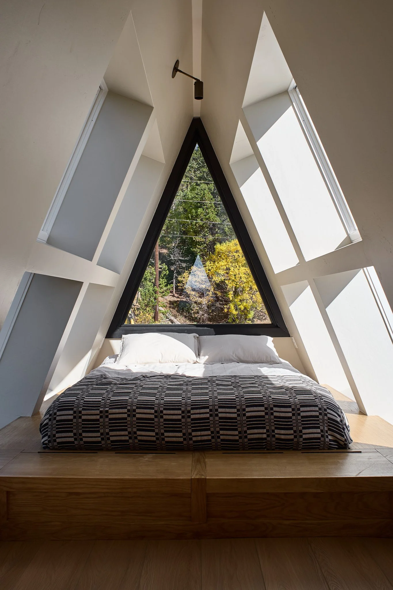 Luxury interior design by Charleston-based Sarah Hart for a custom A-Frame short-term rental, highlighting custom cabinetry, handmade ceramics, curated lighting, and fully bespoke furnishings.