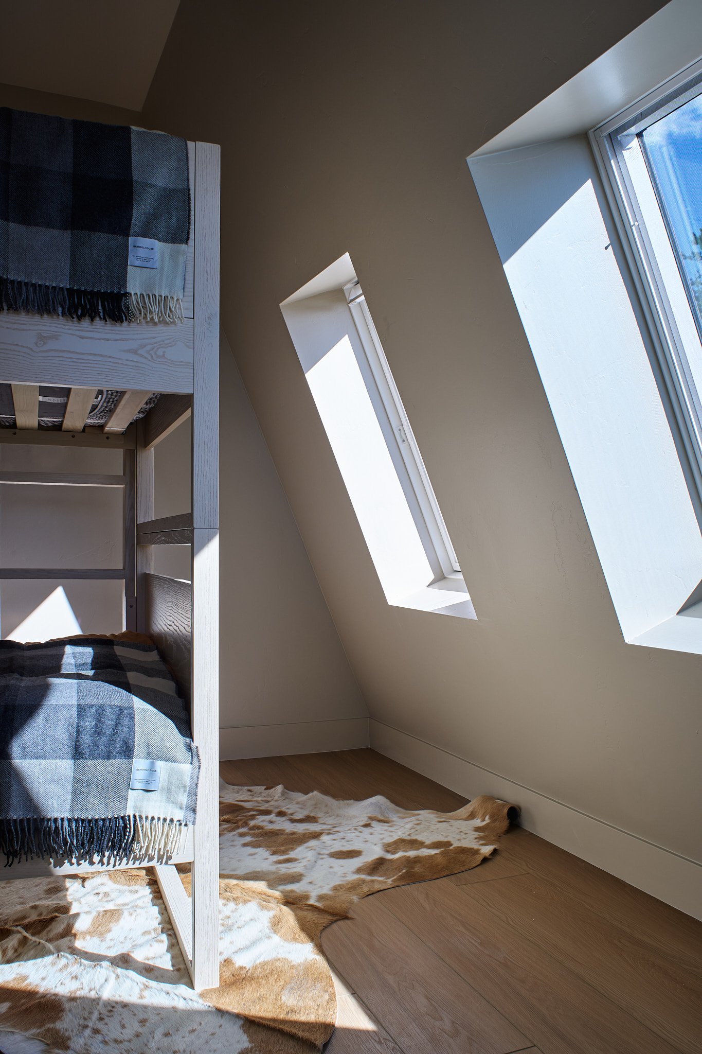 Custom new-build A-Frame project by Sarah Hart Interior Design, a luxury short-term rental featuring handmade ceramics, custom white oak cabinetry, bespoke lighting, and luxury furnishings.