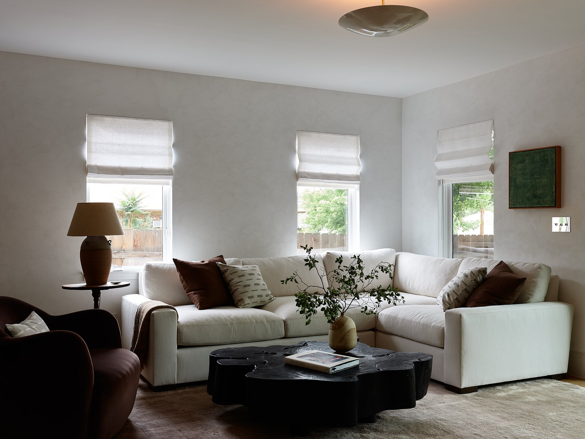 Full-home renovation designed and managed by Charleston interior designer Sarah Hart Interior Design, featuring bespoke furniture, custom sofa, pillows, and a custom built in. This project features plaster walls and custom window treatments. 