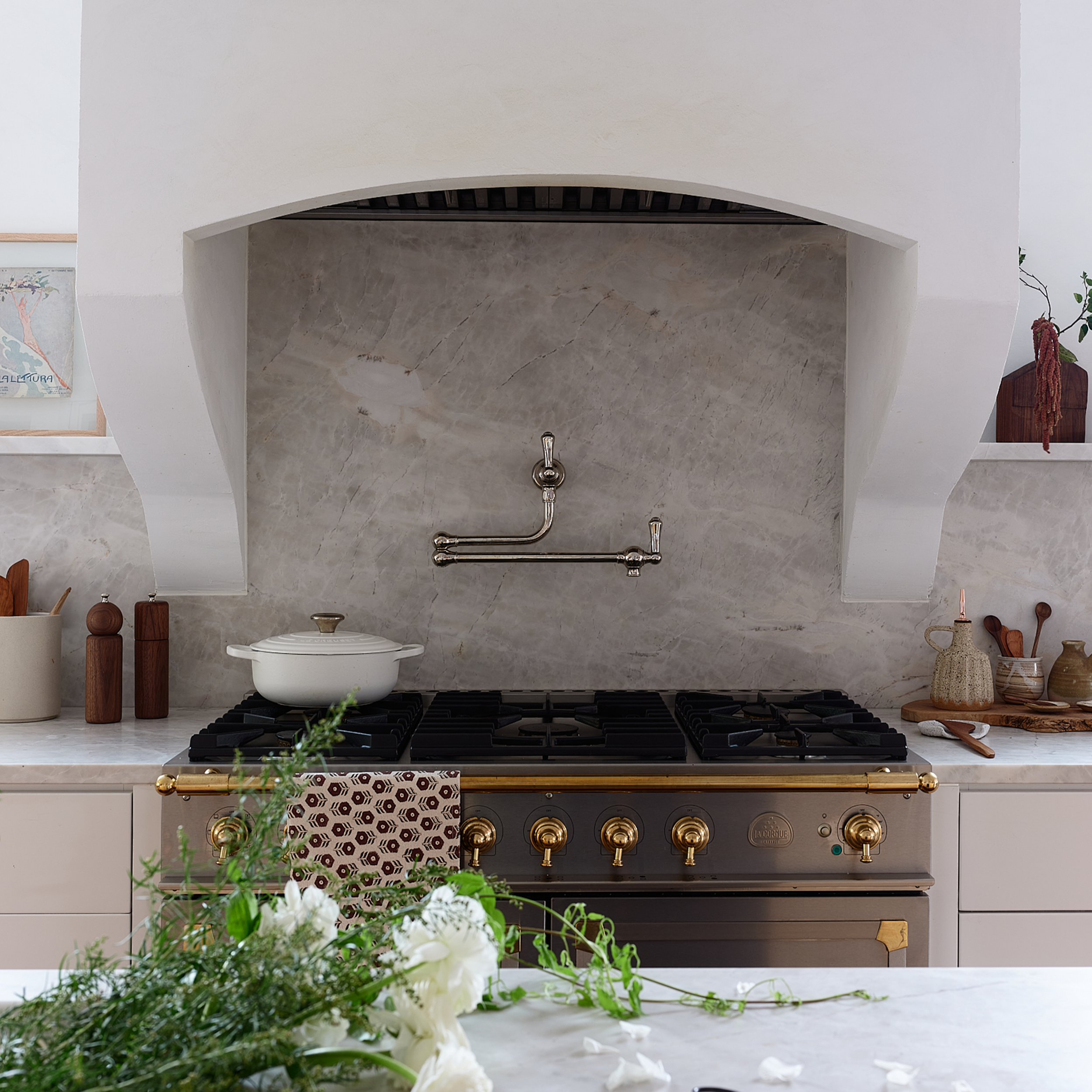 Washington Park project with custom kitchen by Charleston interior designer Sarah Hart Interior Design. Plaster walls, custom cabinetry, marble backsplash.  Custom range hood and la Cornue range. Custom kitchen Charleston South Carolina. 