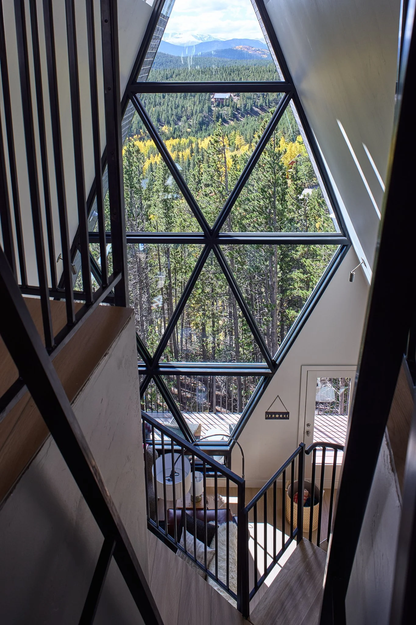Luxury interior design by Charleston-based Sarah Hart for a custom A-Frame short-term rental, highlighting custom cabinetry, handmade ceramics, curated lighting, and fully bespoke furnishings.