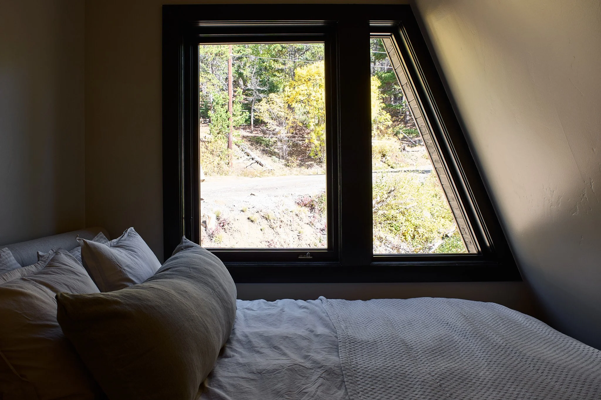 Charleston interior designer Sarah Hart created this luxury short-term rental A-Frame with custom furnishings, white oak cabinetry, handmade ceramics, and one-of-a-kind lighting.