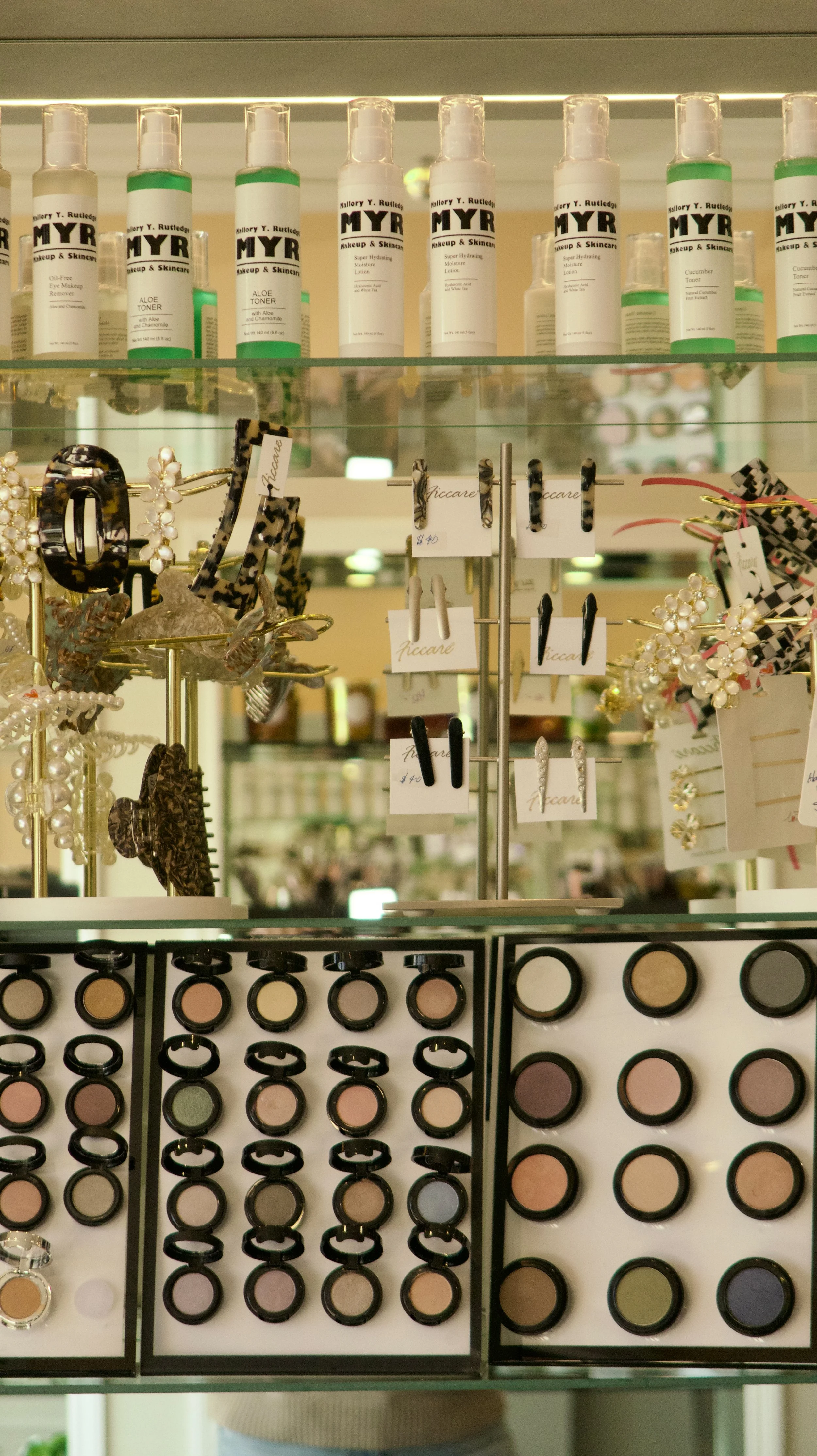 Display shelf with skincare products, jewelry, and makeup.