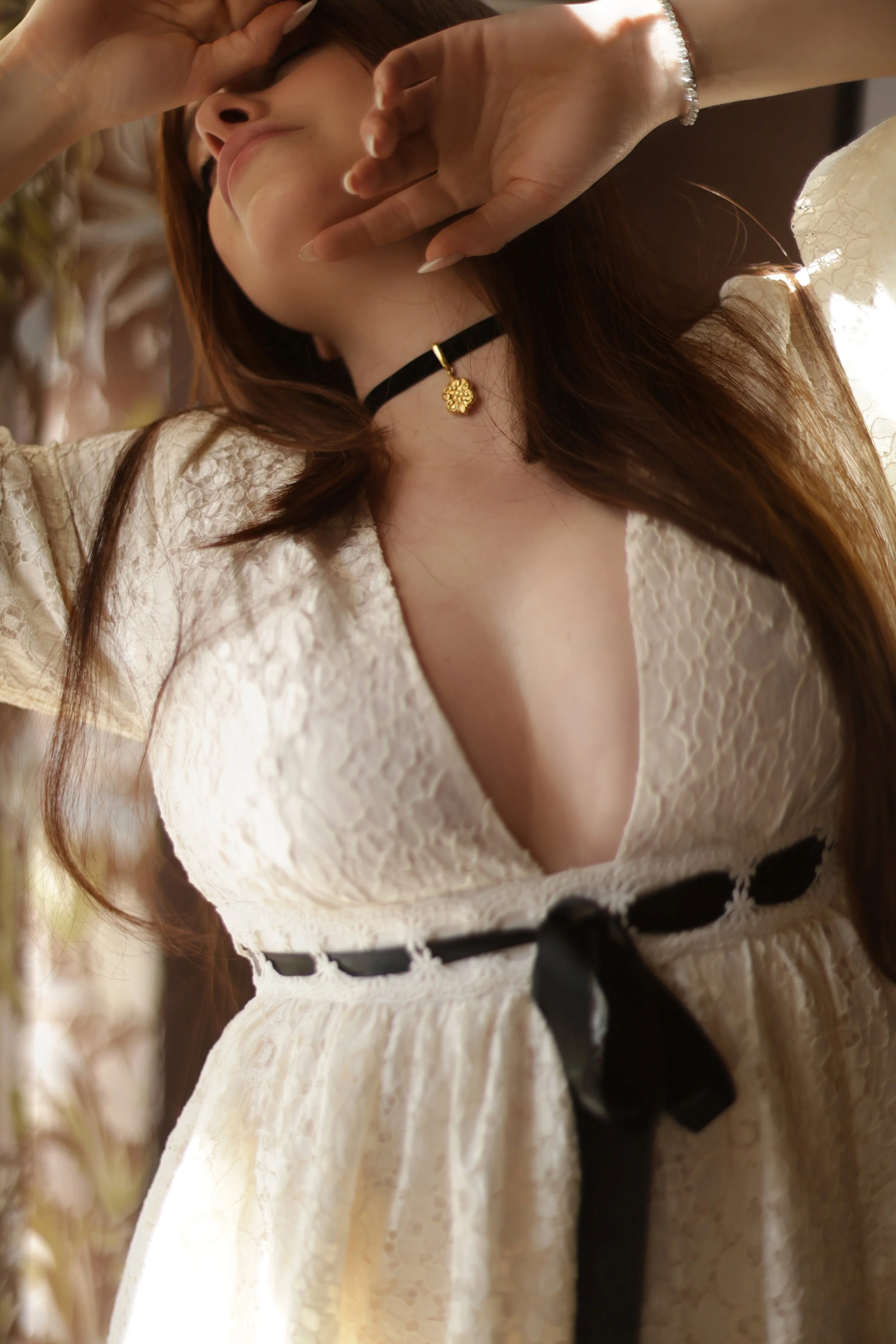 close up shot of woman wearing a white lace dress