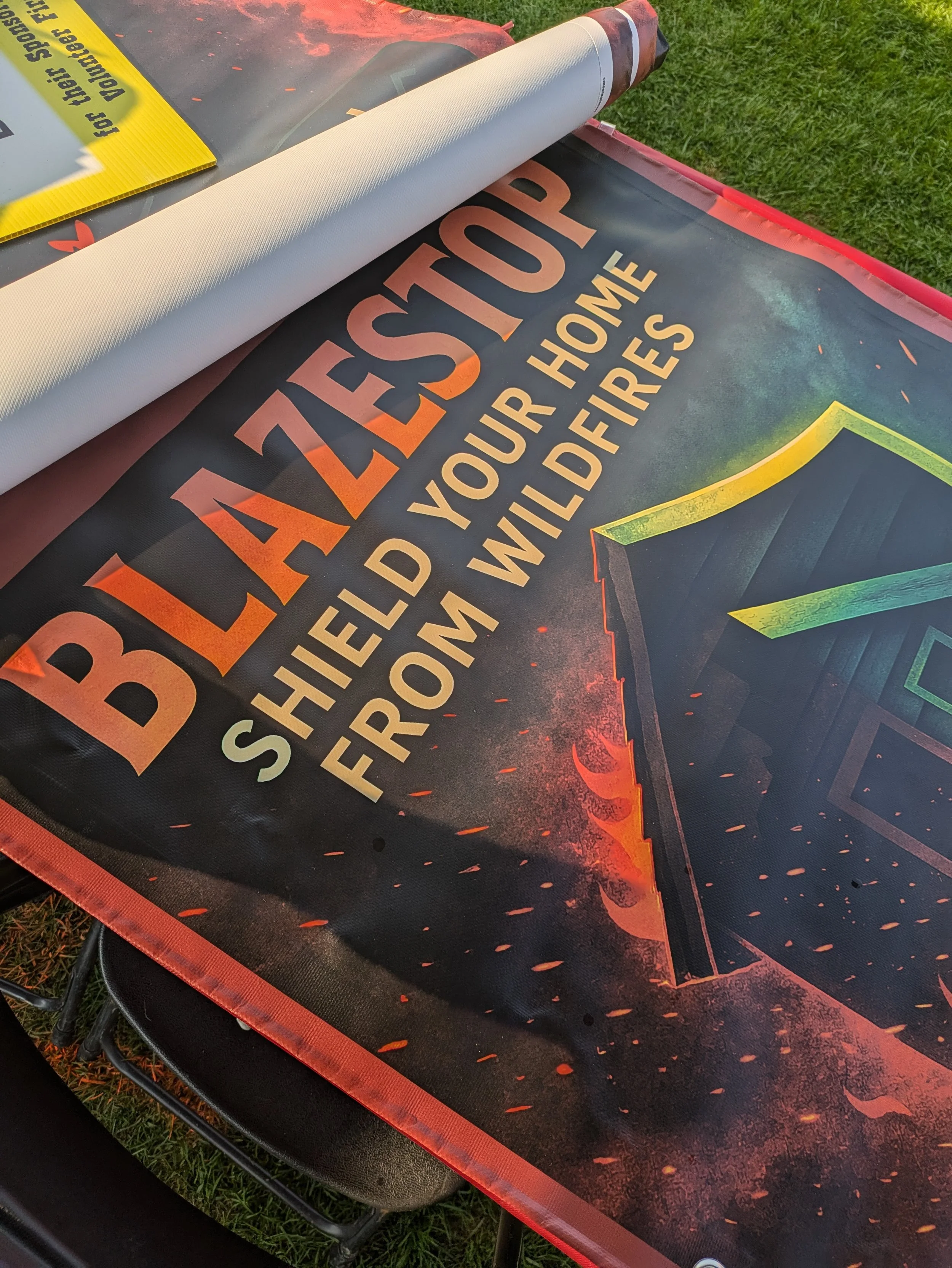 Banner with the text 'Black Leaps' and 'Shield Your Home from Wildfires' along with an illustration of a house with a roof on fire, and flames and sparks in the background.