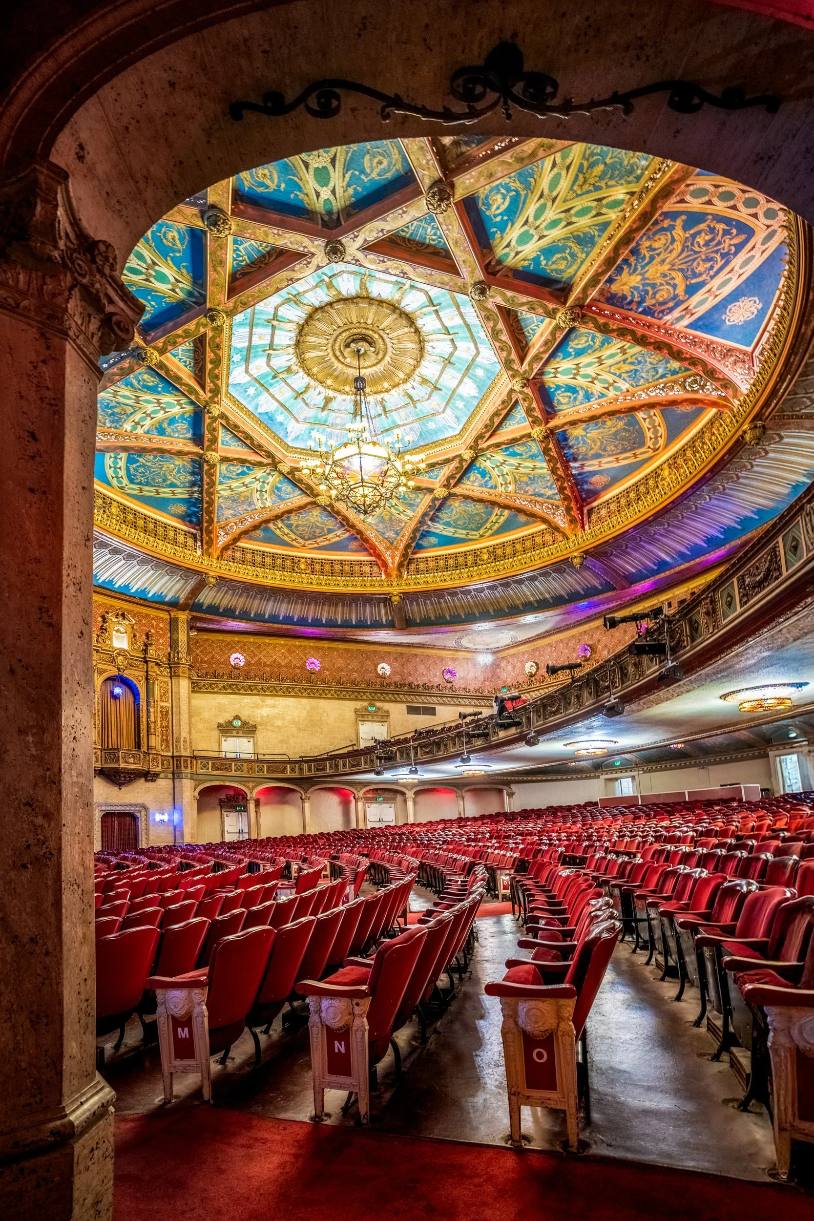 Historic Warnor theater interior from hallway showing painted ceiling dome and red seating— architectural photography by BK Captured