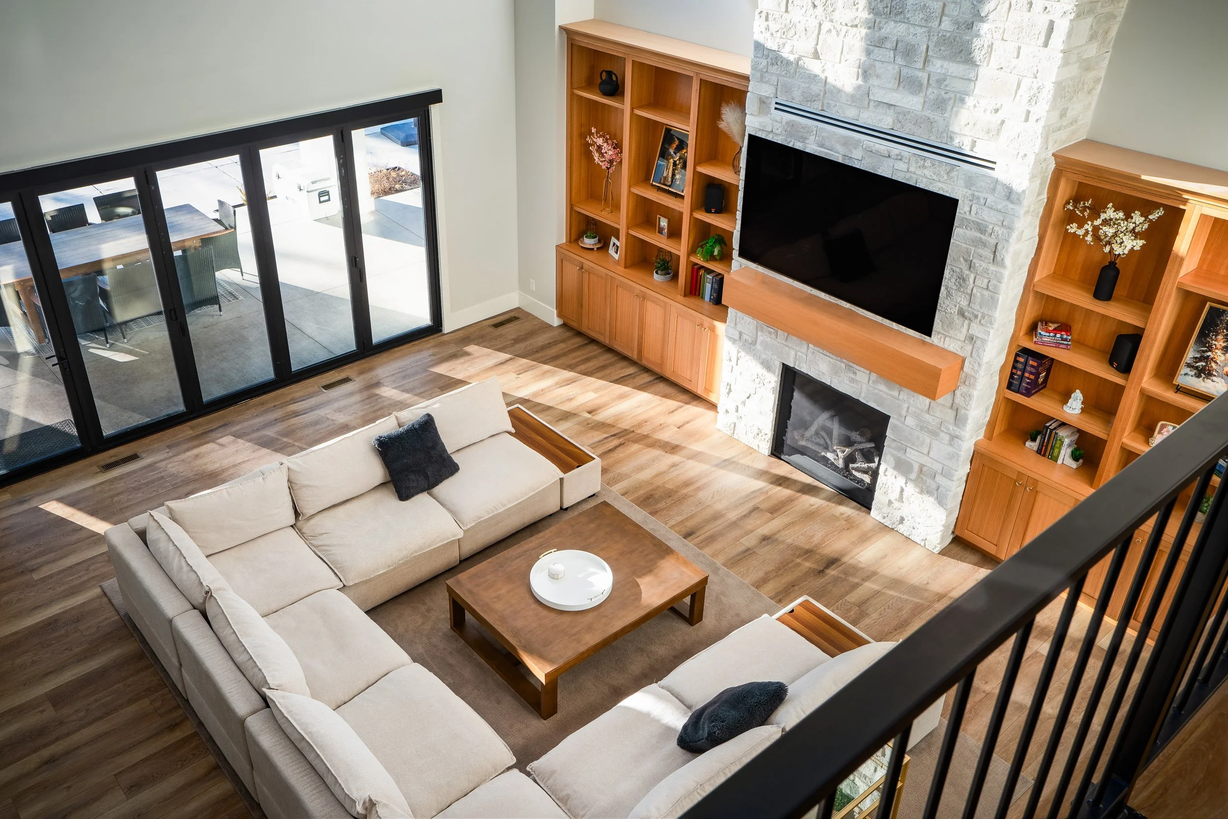 Custom home living room with sliding glass doors and built-in shelving — interior architectural photography by BK Captured