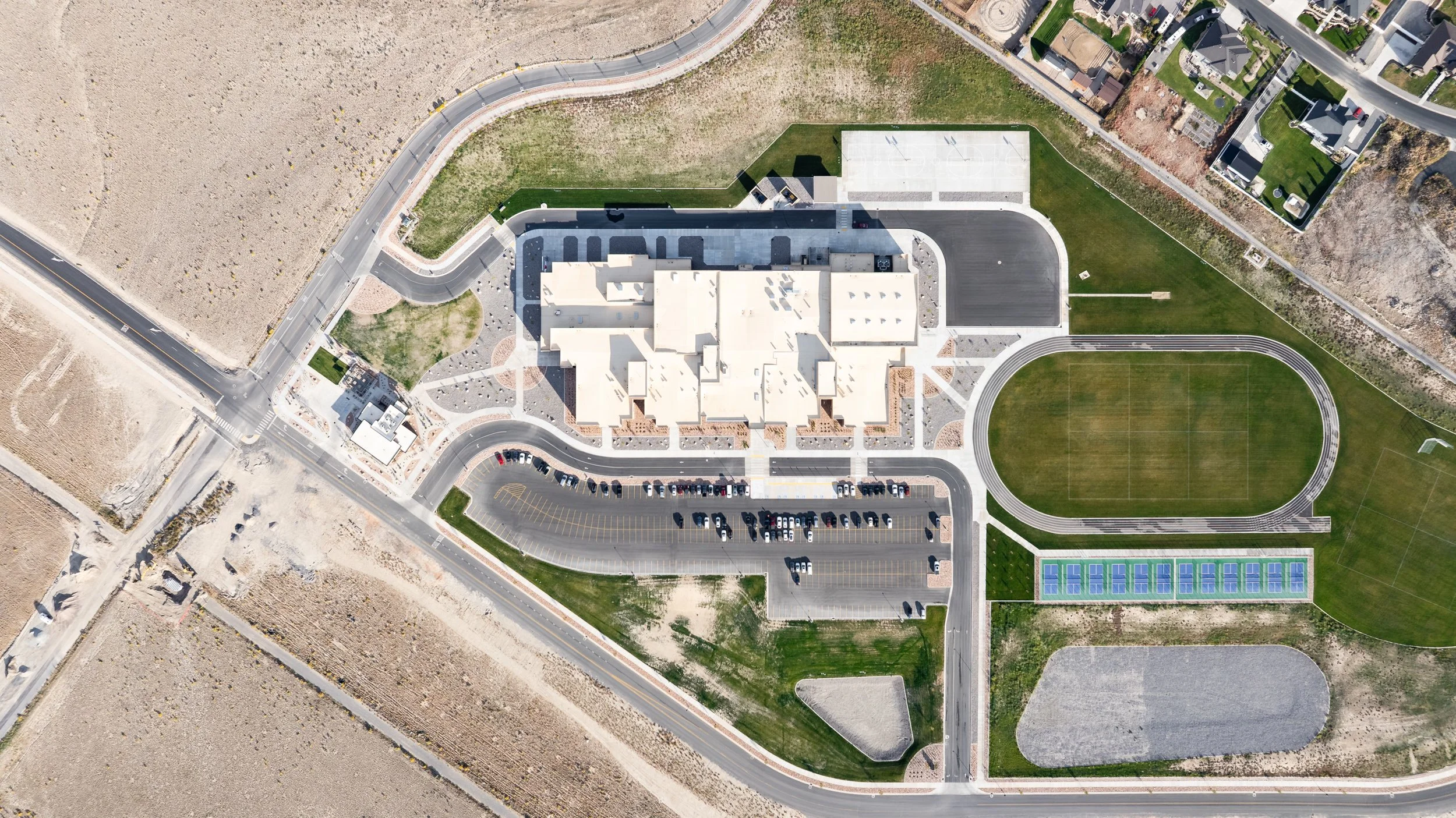 Overhead aerial view of school campus showing building layout and athletic facilities — educational facility photography by BK Captured