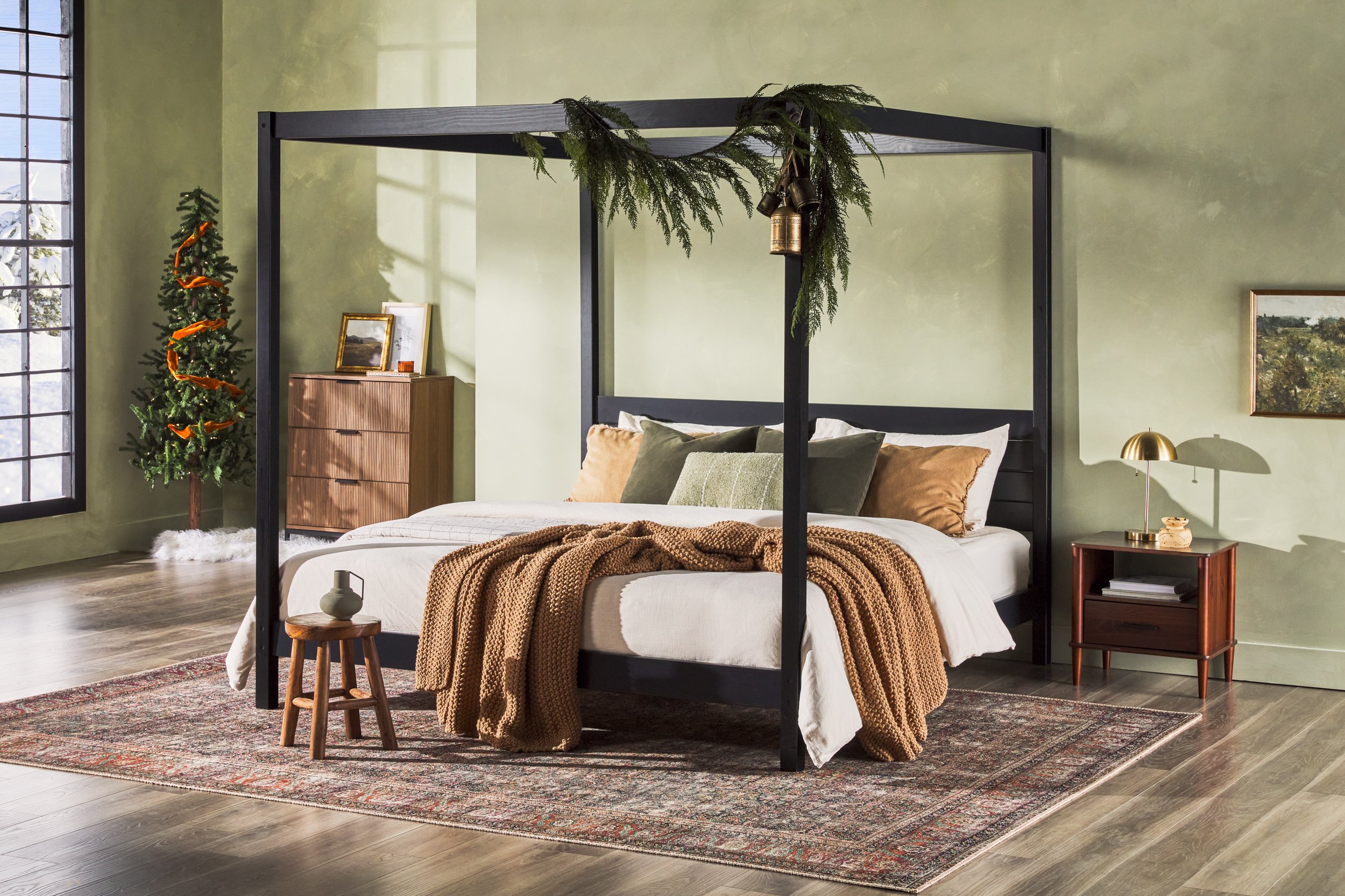 Walker Edison black metal canopy bed in richly styled bedroom with warm textiles and ambient lighting — lifestyle furniture photography by BK Captured