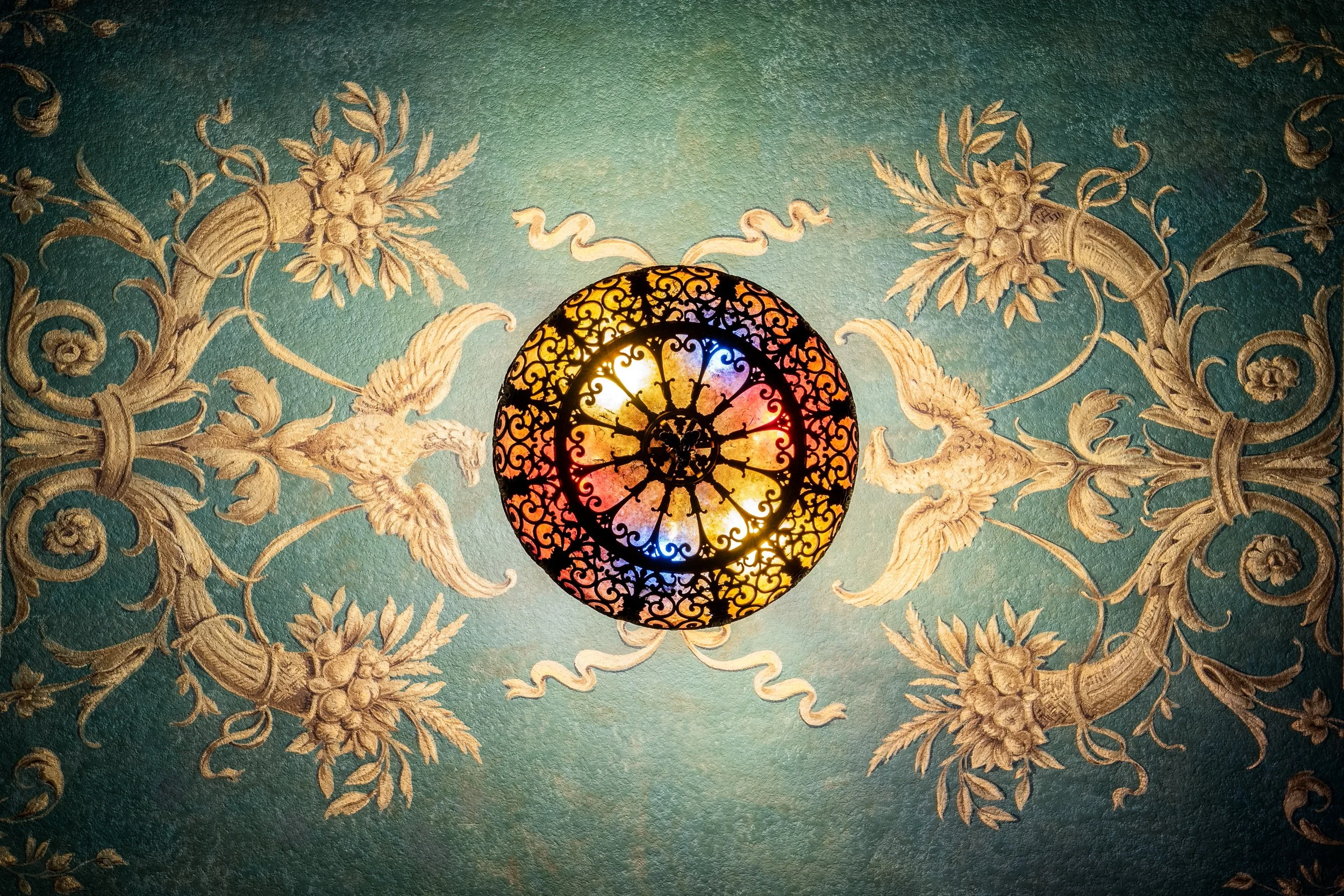 Historic Warnor theater ceiling chandelier medallion with painted floral surround — architectural detail photography by BK Captured