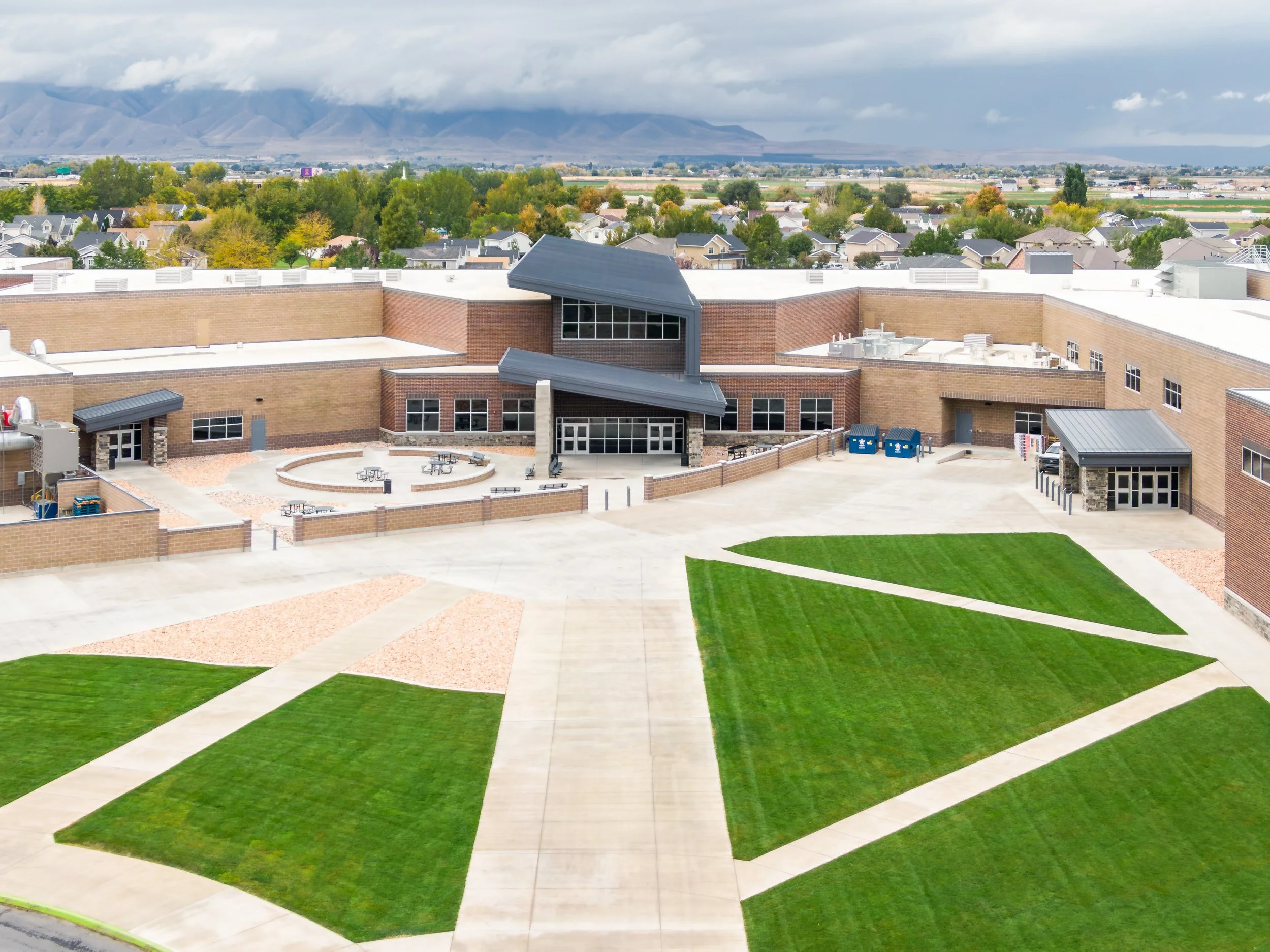 Aerial view of school campus with green courtyard and playing fields — educational facility photography by BK Captured