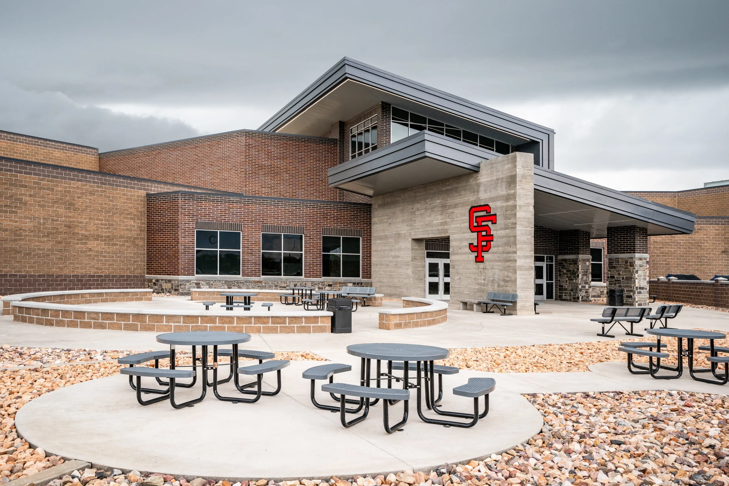 School exterior brick facade with Spanish Fork entry signage and landscaping — educational facility architectural photography by BK Captured