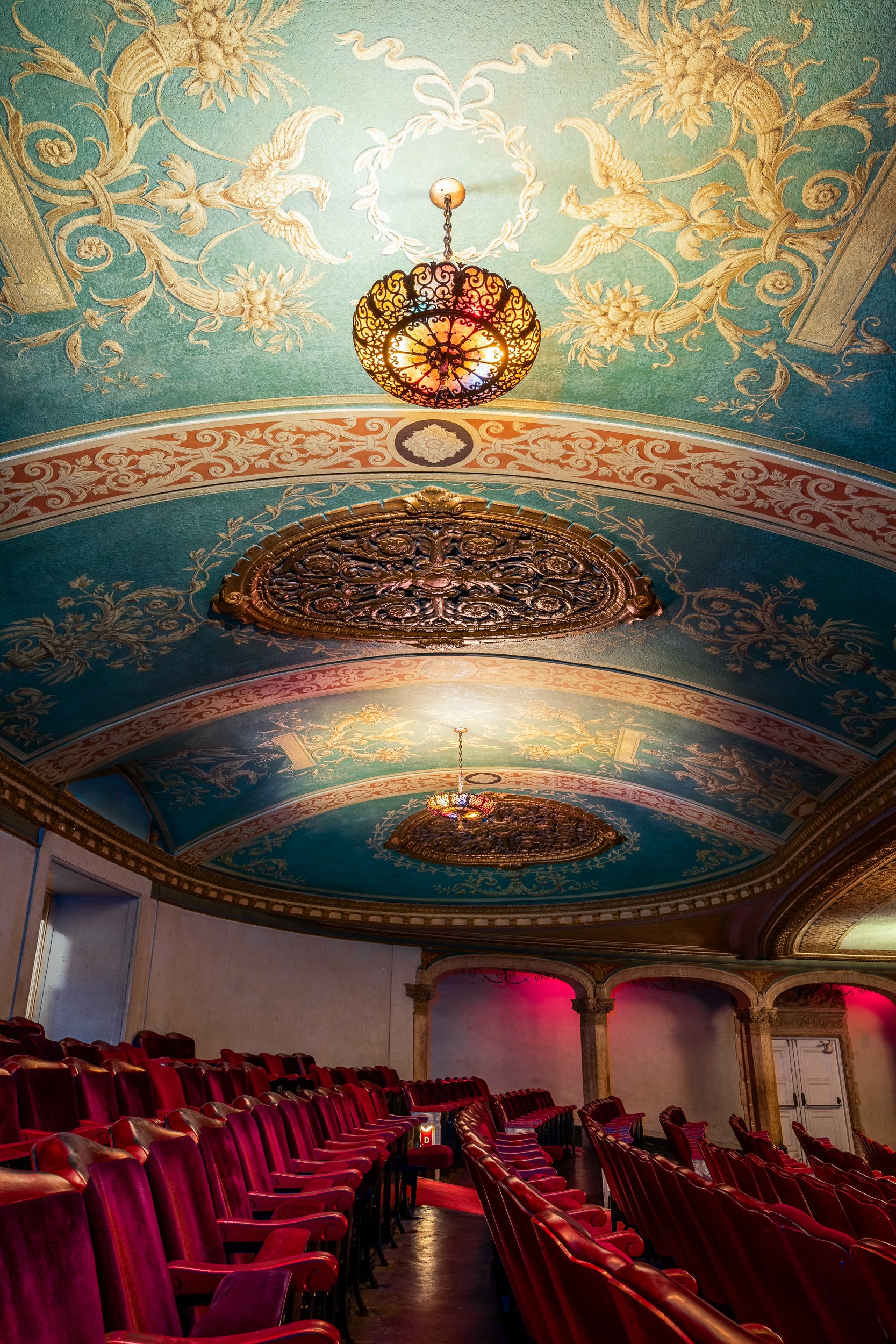 Gilded ornate ceiling medallion in historic theater — architectural detail photography by BK Captured