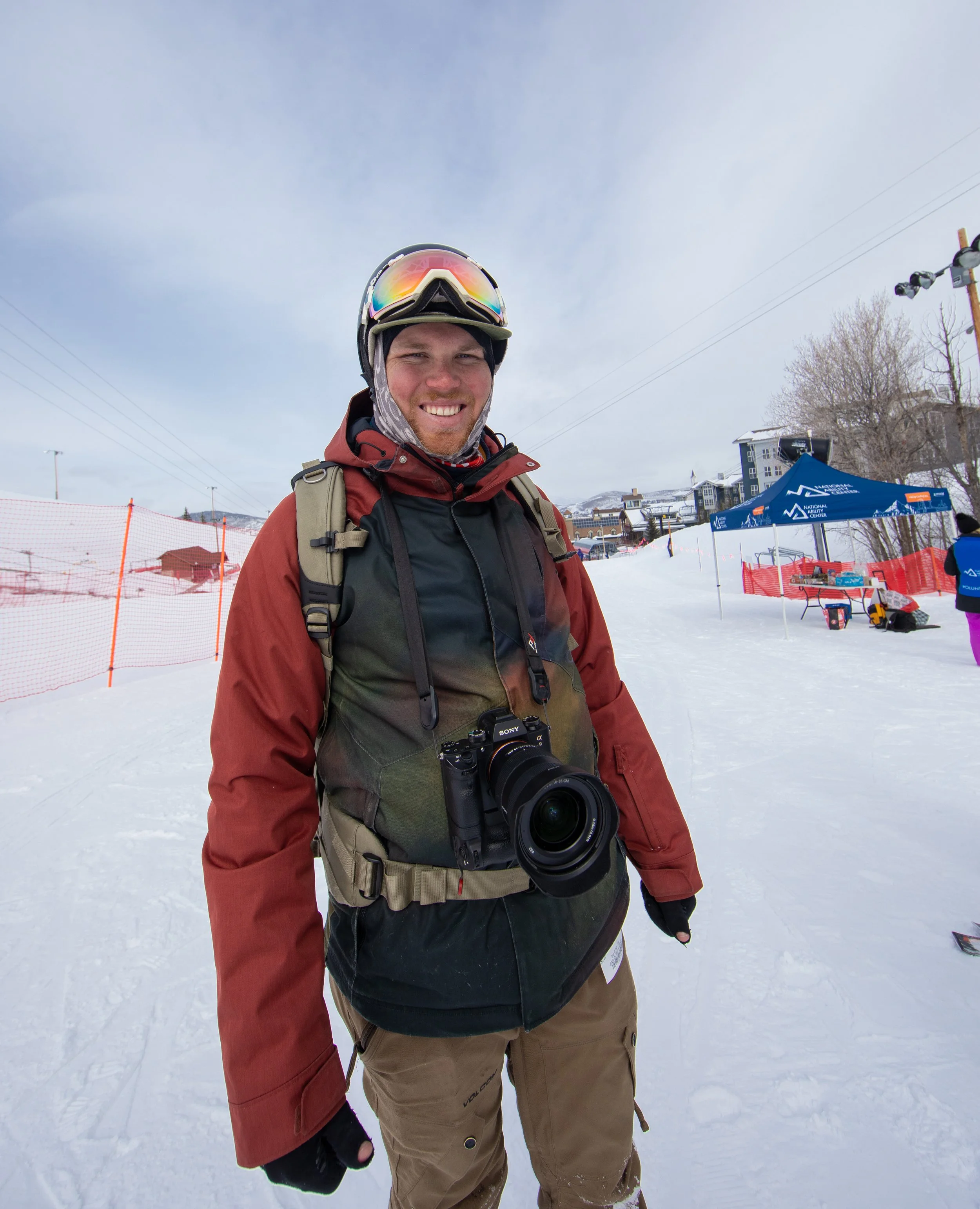 Berin Klawiter on a ski slope with camera gear and backpack — commercial photographer shooting on location