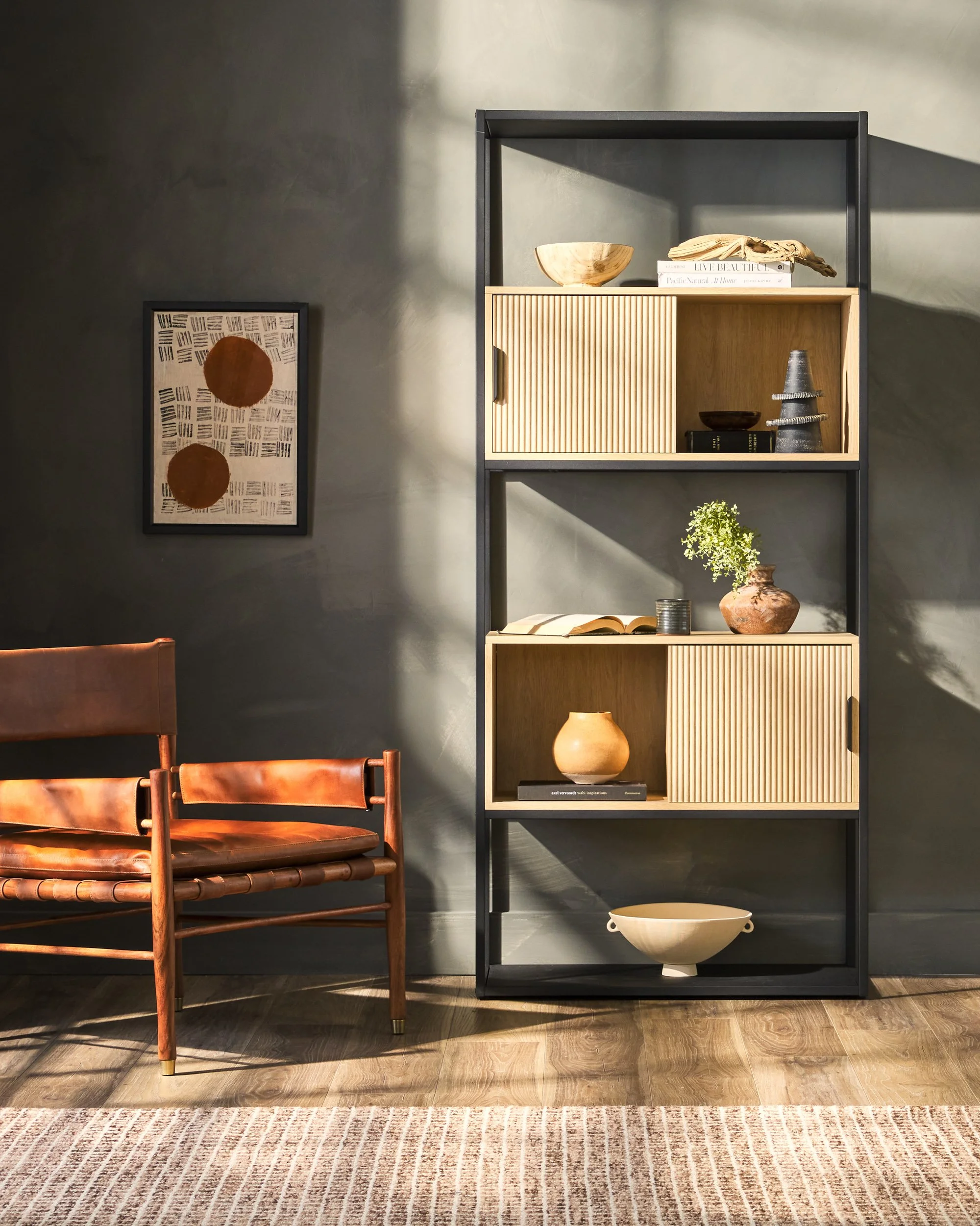 Walker Edison shelf in dramatic light and dark living room — editorial furniture photography by BK Captured