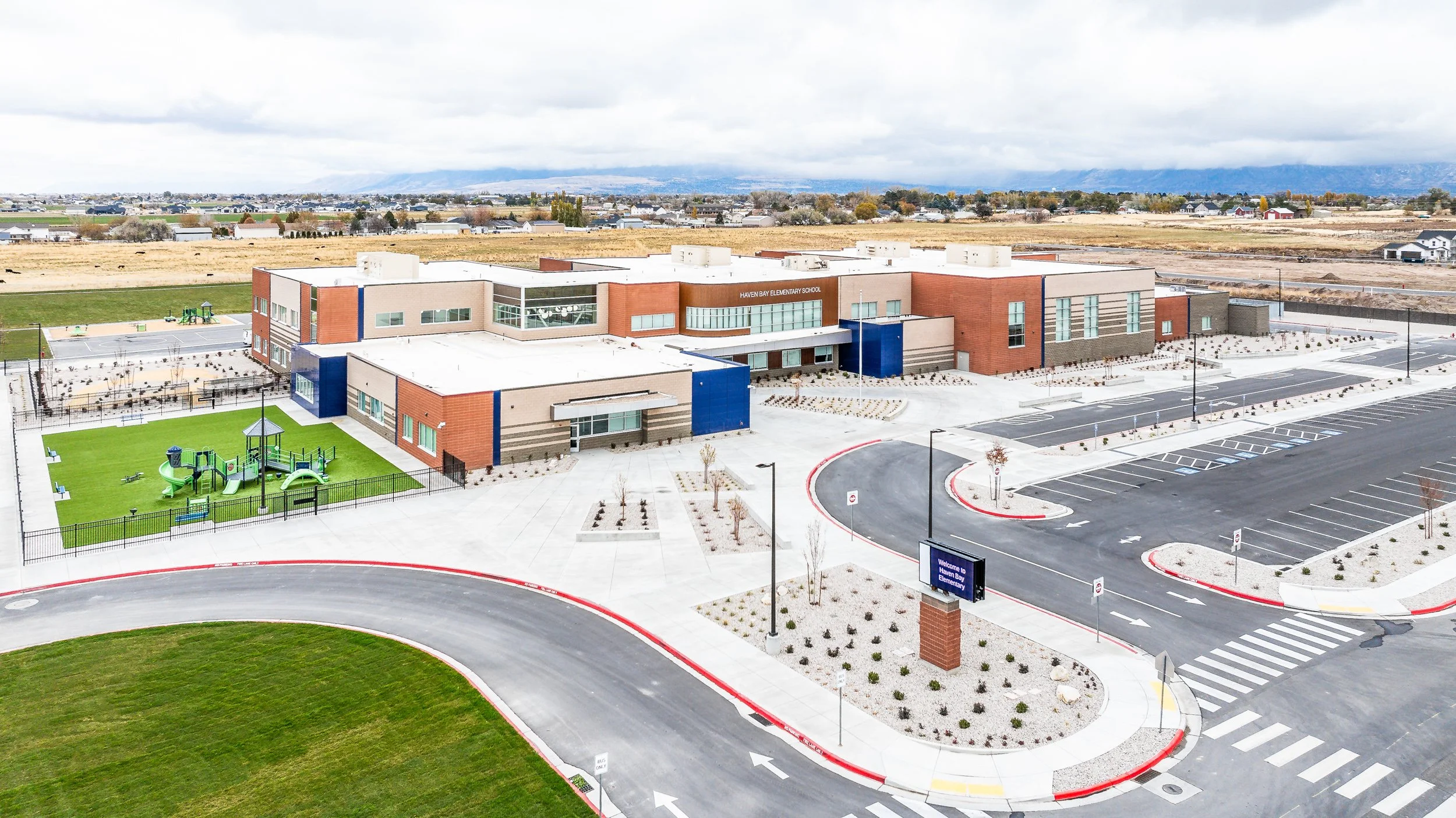 Aerial view of school campus with green courtyard and dynamic loading & unloading zone — educational facility photography by BK Captured