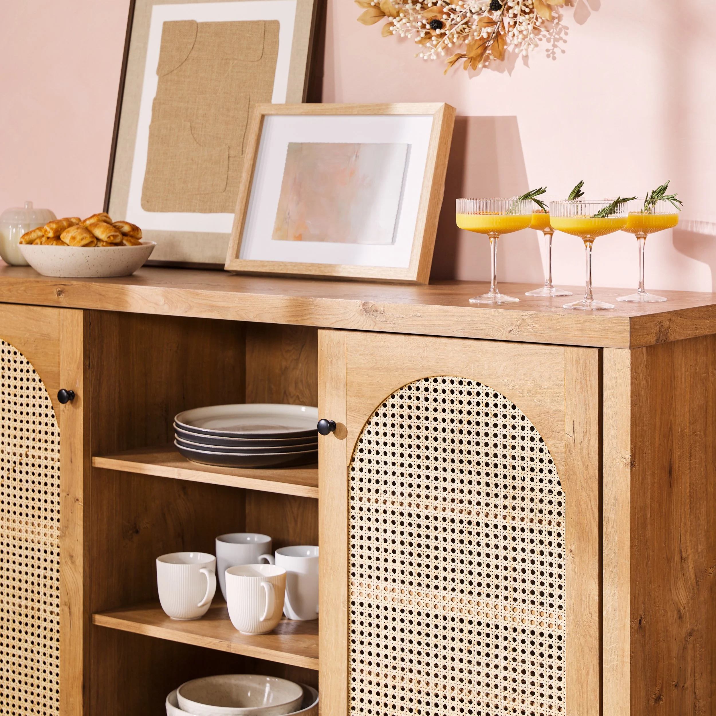 Walker Edison cane-door cabinet styled with ceramics, glassware, and dried florals in warm interior — lifestyle furniture photography by BK Captured