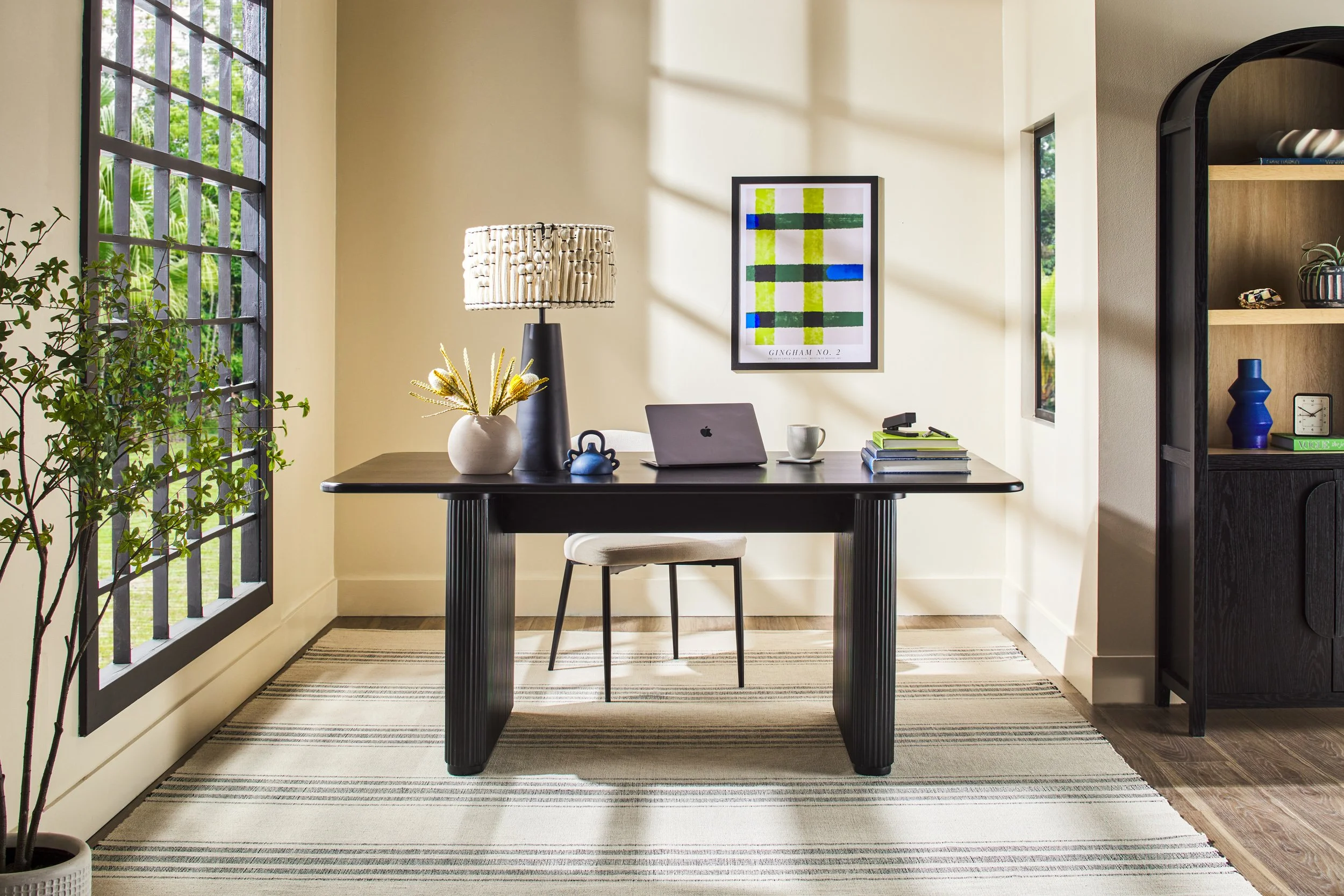 Walker Edison black desk and cabinet in bright styled office with arched window and warm decor — lifestyle furniture photography by BK Captured