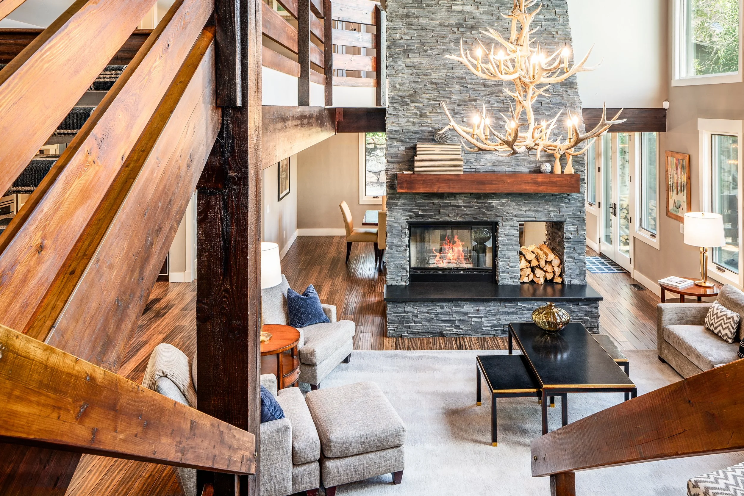 Rustic wooden beam ceiling with chandelier in custom home interior — architectural photography by BK Captured