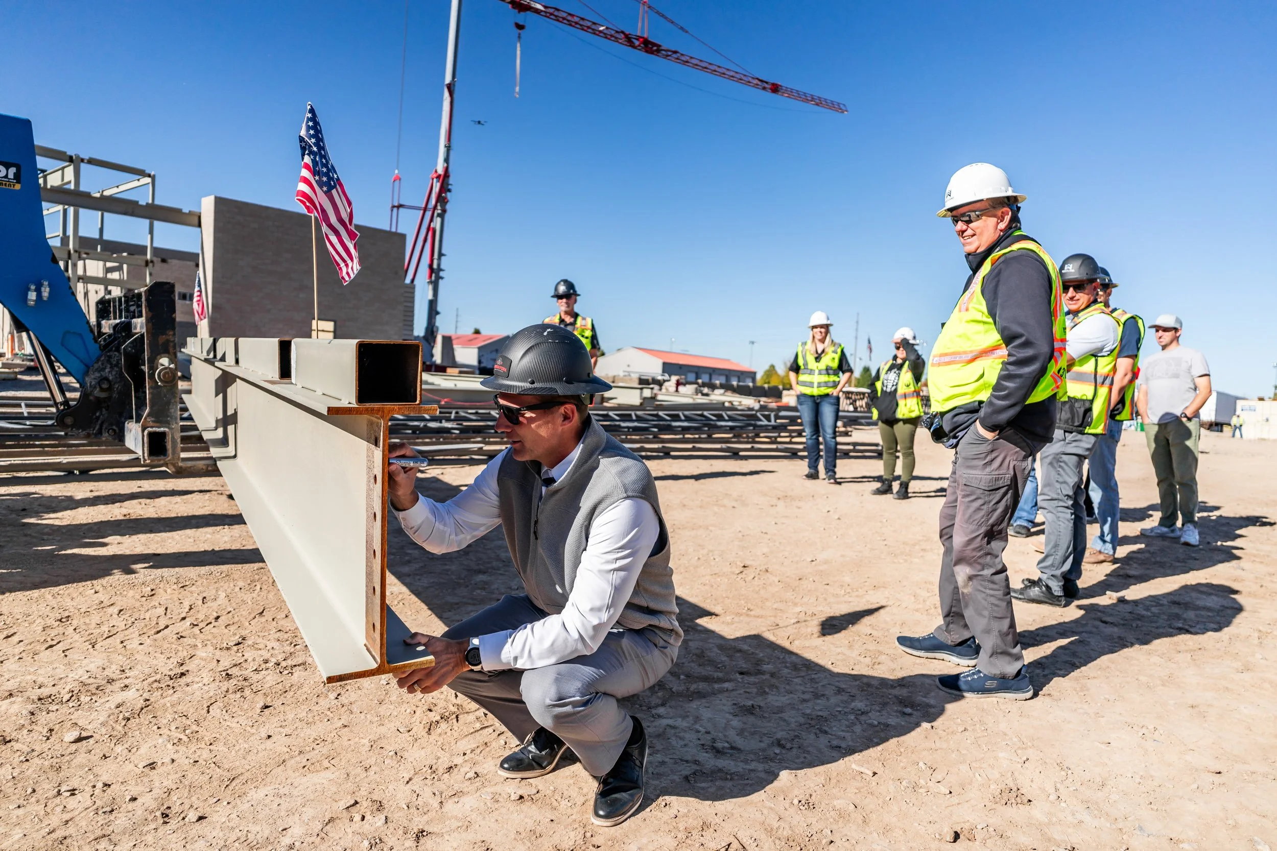 Construction crew signing bean during Beam Ceremony for the Spanish Fork Rec Center— commercial construction documentation by BK Captured