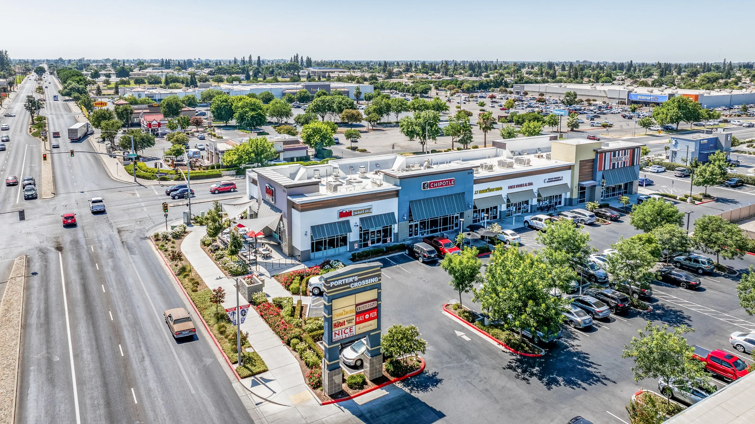 Aerial view of the Porter's Crossing retail center with storefronts, parking, and a major roadway