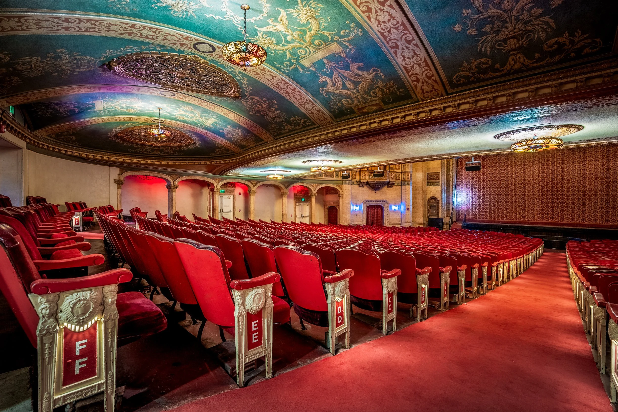 Historic Warnor Theater interior from ground level aisle with ornate ceiling and red seating — architectural photography by BK Captured