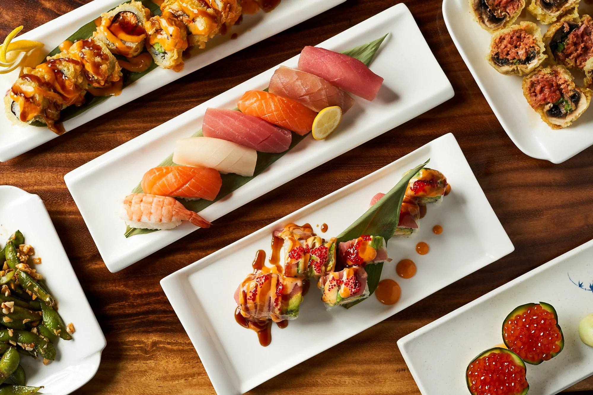 Sushi platter flat lay photograph on a wooden table— food product photography by BK Captured