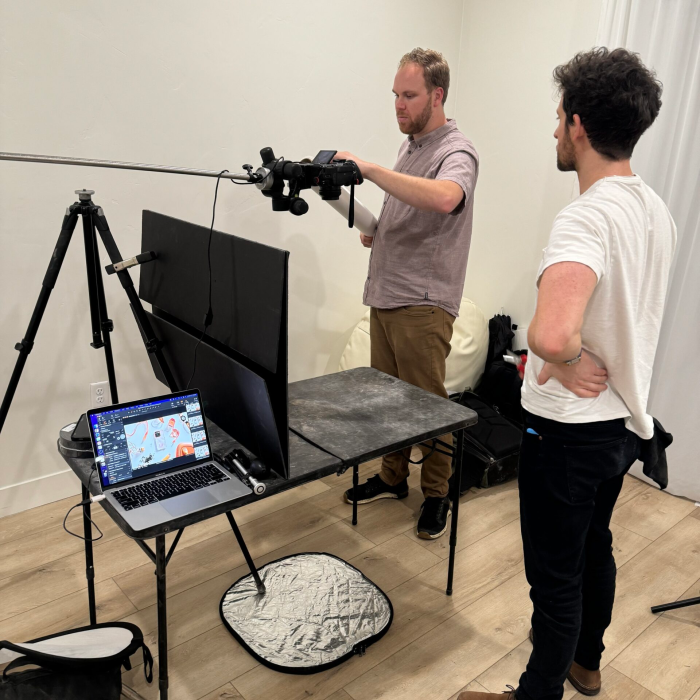 Berin Klawiter directing a tethered product shoot in studio with lighting setup and laptop on set — BK Captured behind the scenes