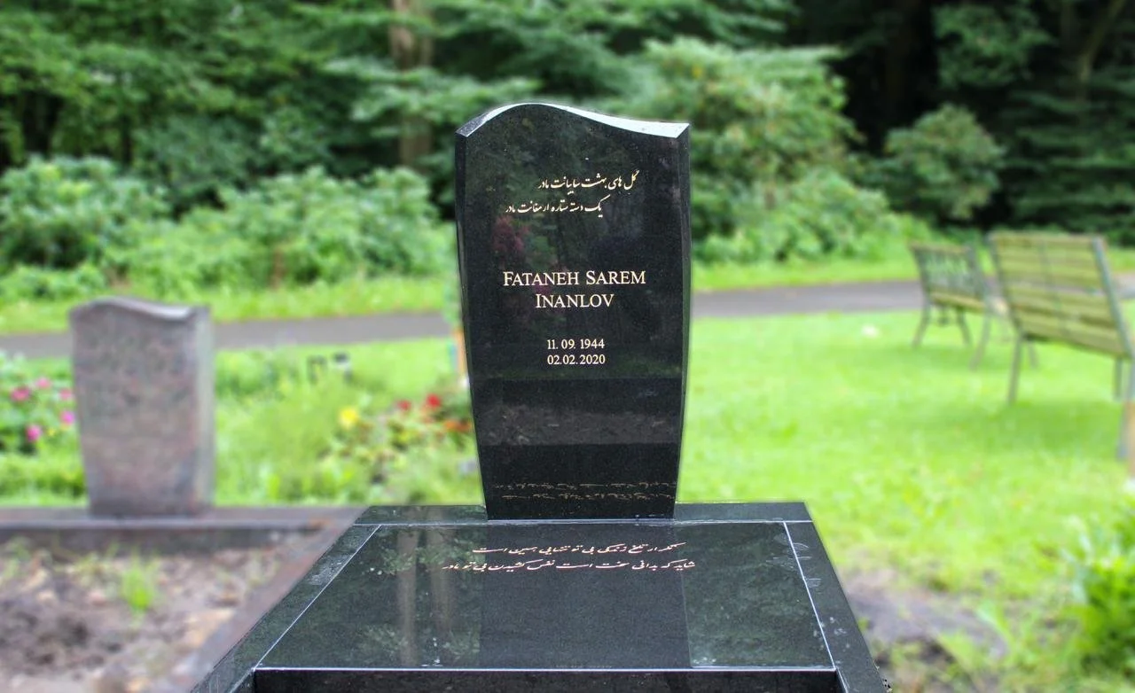 Grabstein in Indian Black mit mehrsprachiger Inschrift.