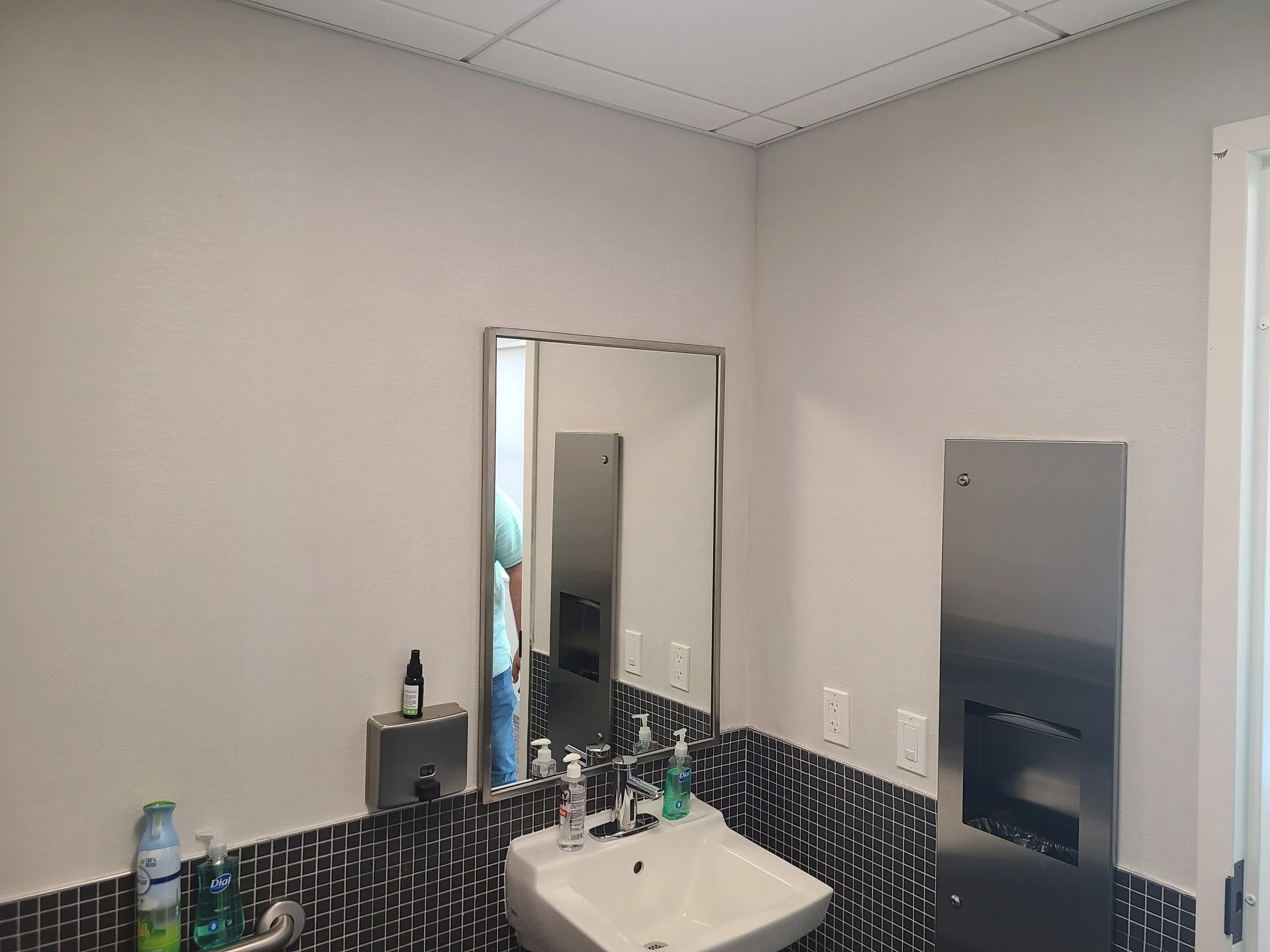 Add updated restroom accessories and built in trash receptacle.