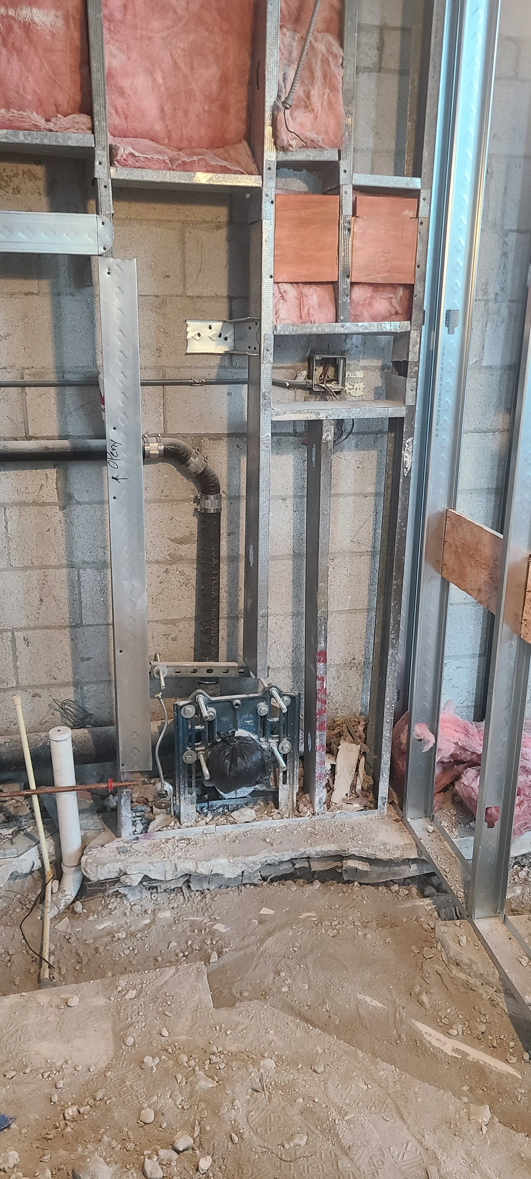 Demolition at old restroom for new wall hung toilet with flushometer