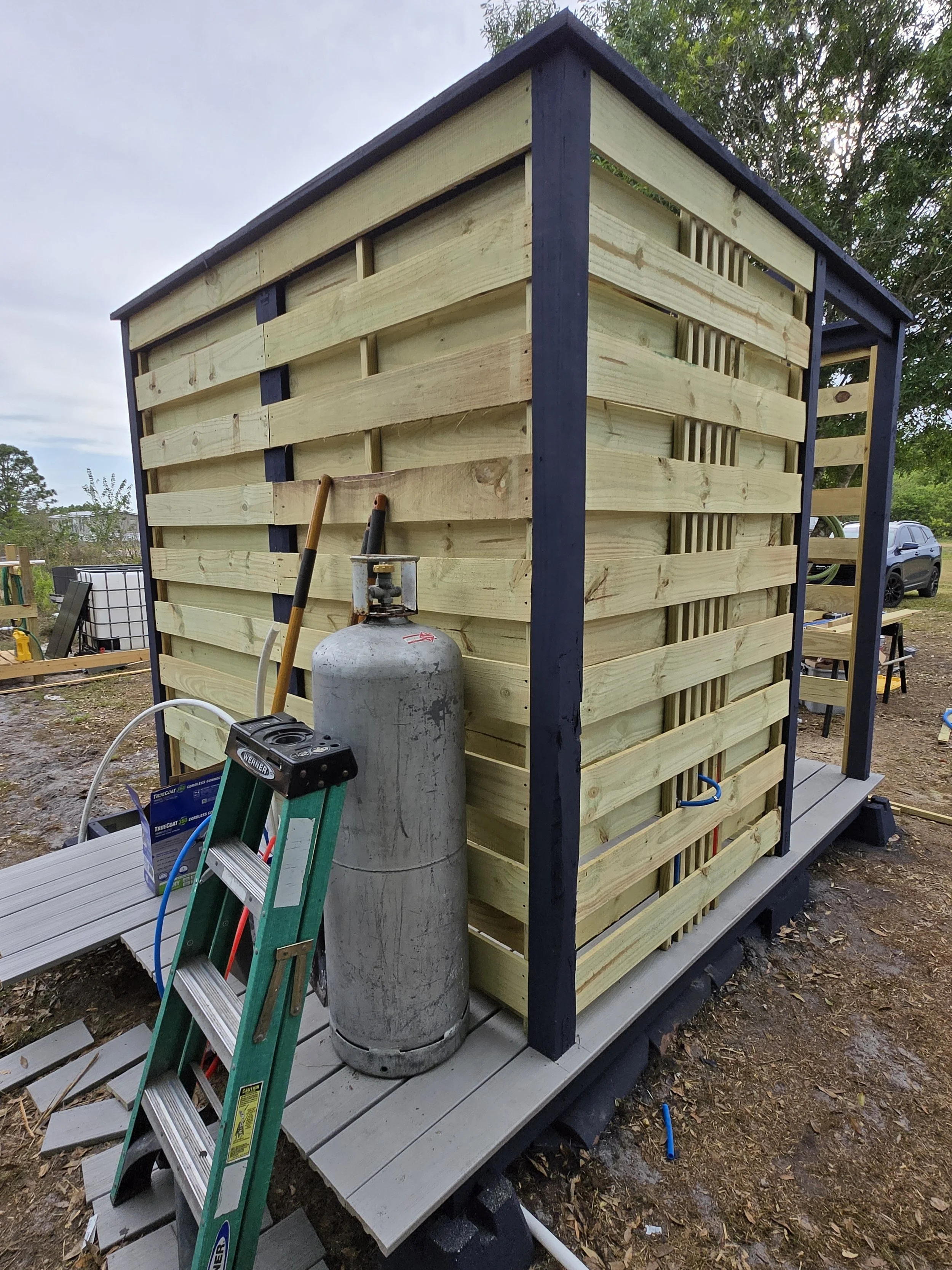 Backside of off grid shower, propane and electric for hot water.