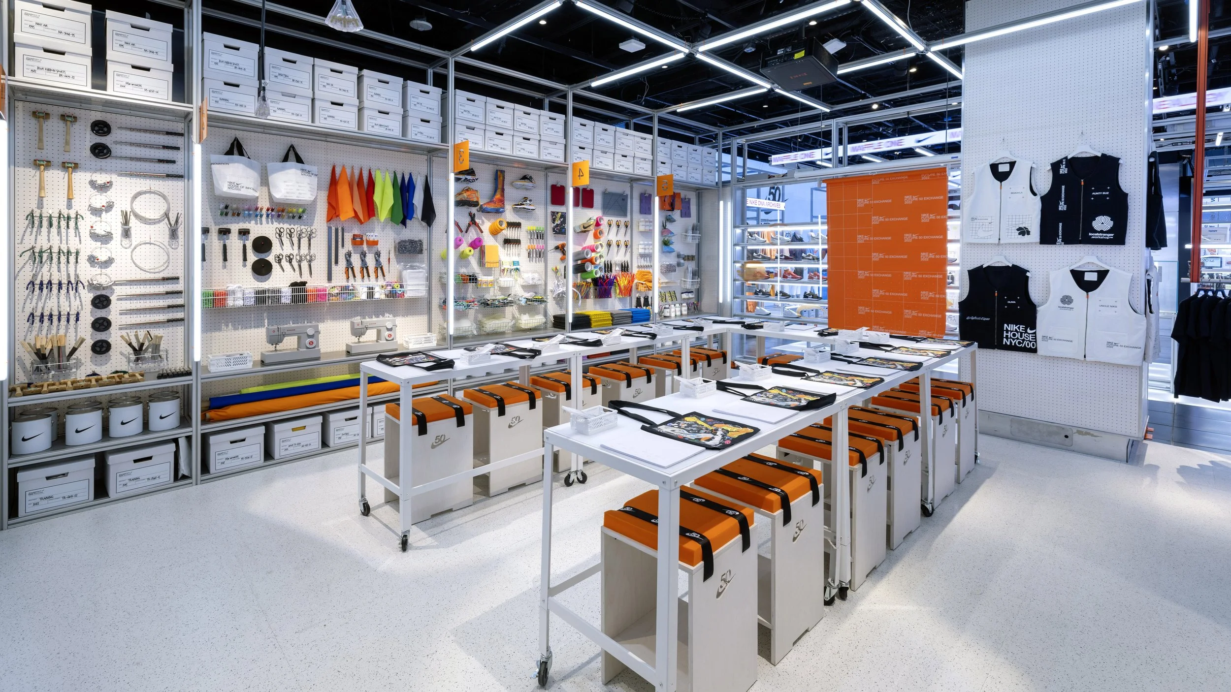 Sports store display with tools, accessories, sports apparel, and branded items arranged on shelves and tables.
